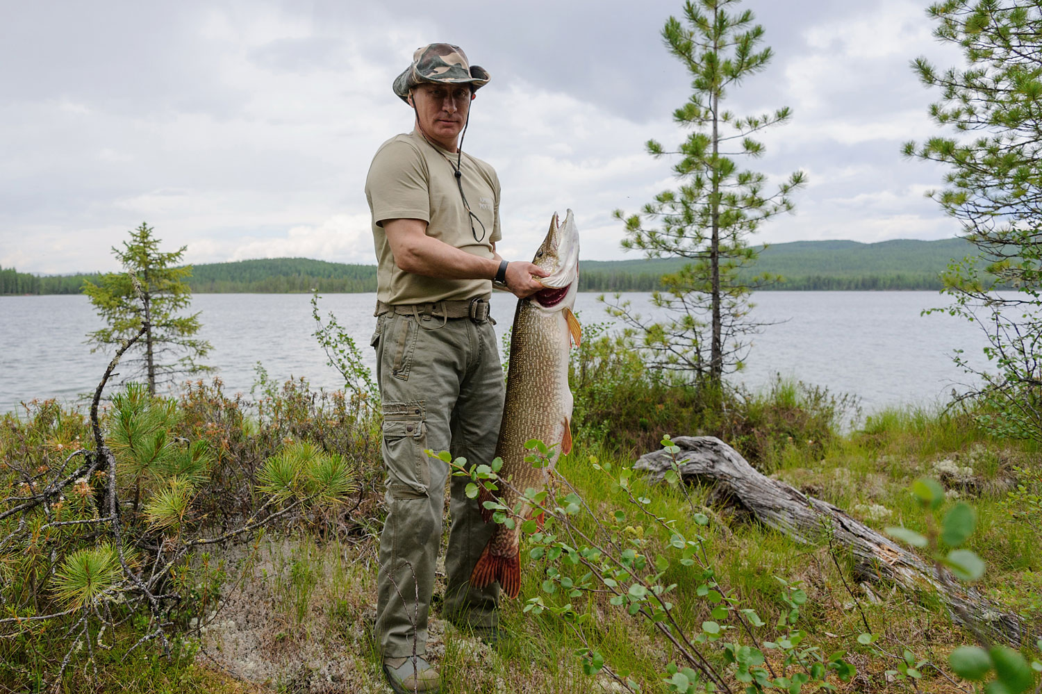 President Vladimir Putin holding a huge pike fish, after he caught it in the Tyva region on July 20, 2013 during his vacation.
