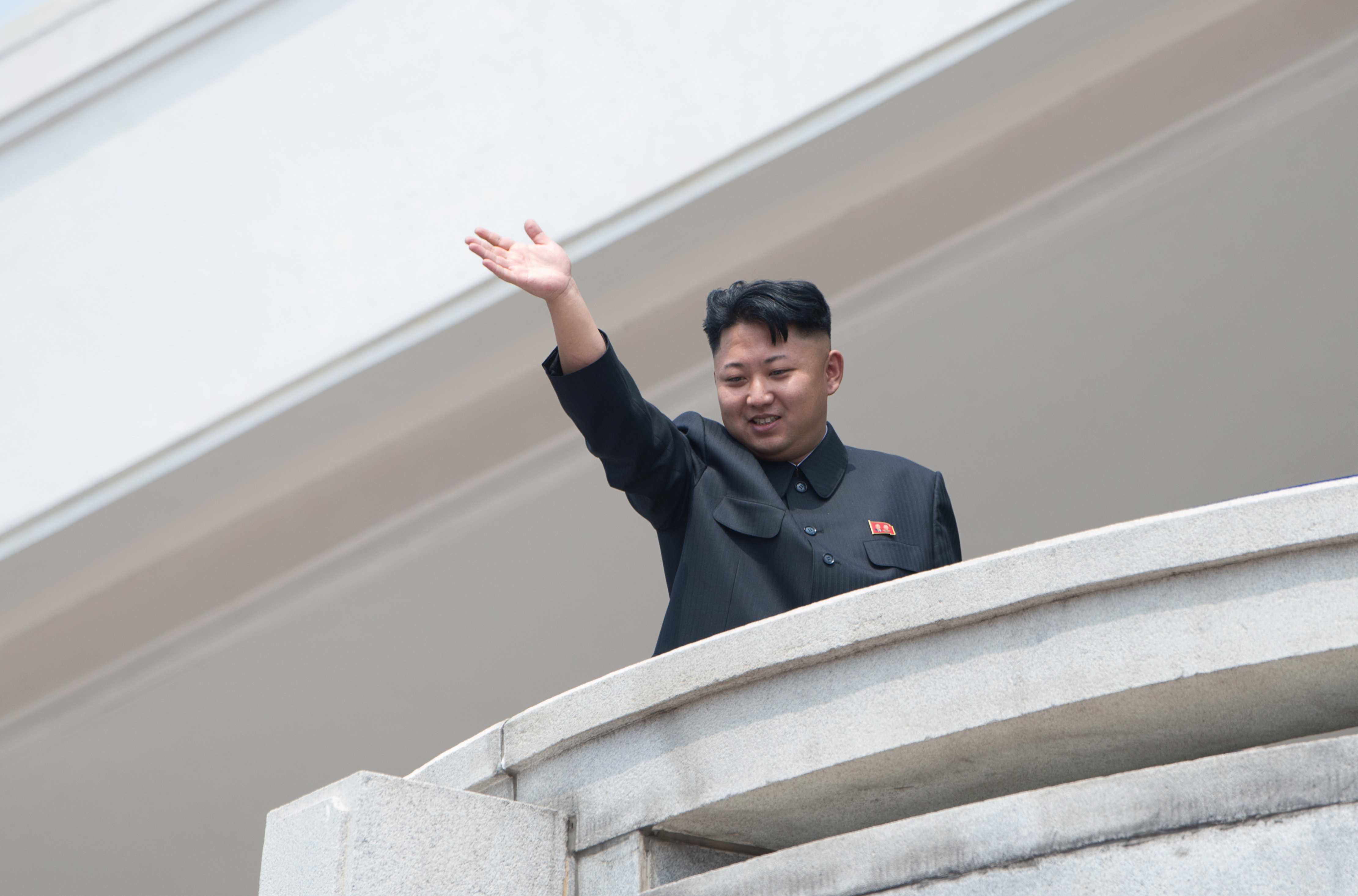 North Korean leader Kim Jong-Un waves to the crowd during a military parade at Kim Il-Sung square in Pyongyang on July 27, 2013. (Ed Jones—AFP/Getty Images)