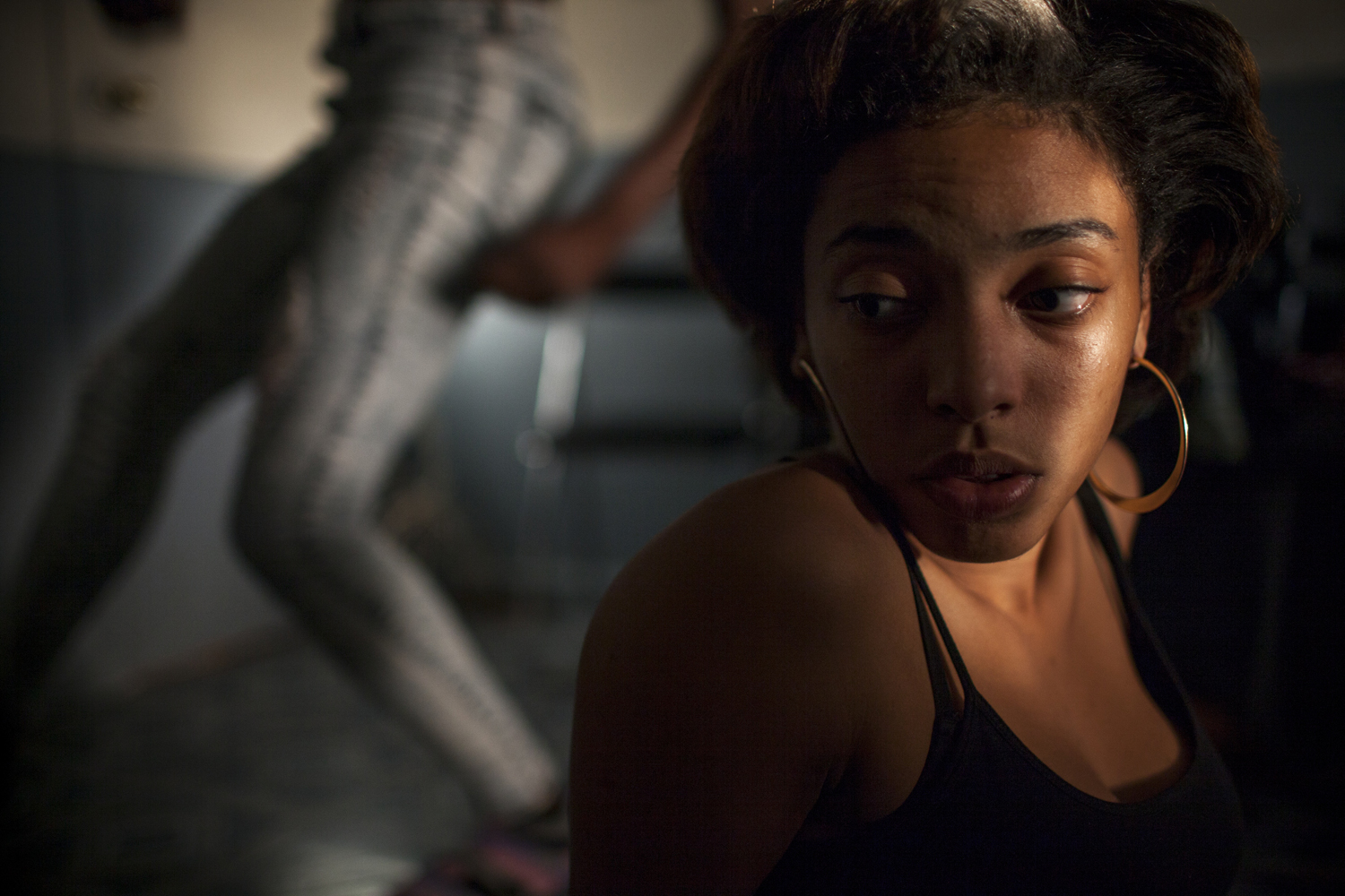 August 19, 2013. Sarah sits on her friend Syrin's bedroom floor as Velvet runs through dance moves behind her. Syrin is the head of Zero Nation, a collective of Dancehall Dancers based in Flatbush and East New York. Dancehall is a style of Jamaican music and dance, known for its highly sexual lyrics and  acrobatic choreography. For Sarah, a teenage Dancehall Queen and ballerina from Flatbush, Brooklyn, dance is her identity and passion.