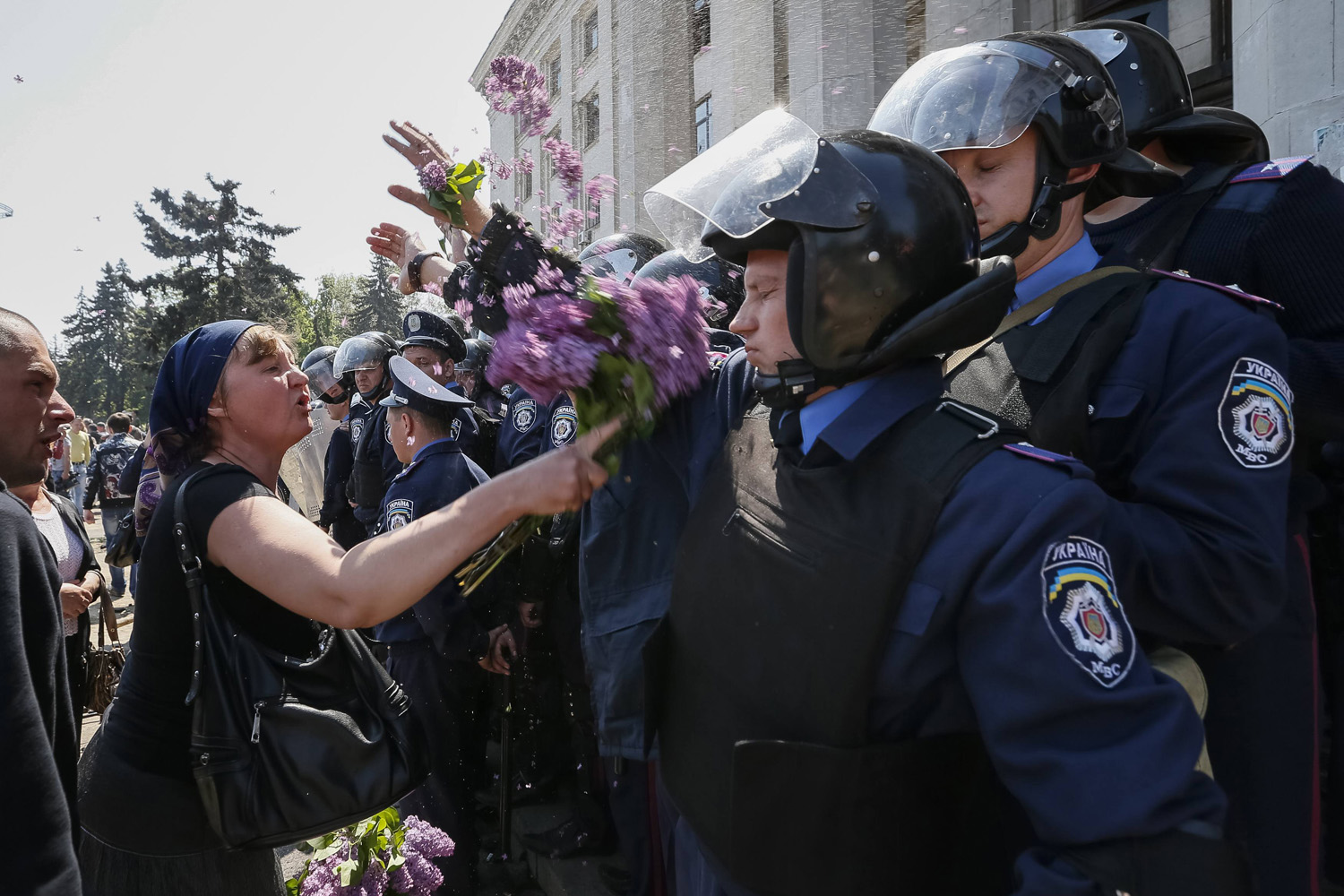 Woman argues with members from the Ukrainian Interior Ministry security forces during a rally outside a trade union building in Odessa