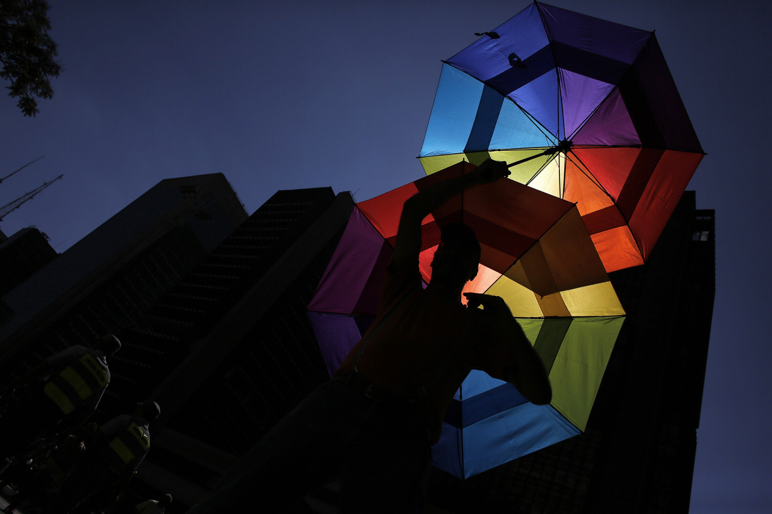 A reveller holds up rainbow coloured umbrellas during the 18th Gay Pride Parade in Avenida Paulista in Sao Paulo