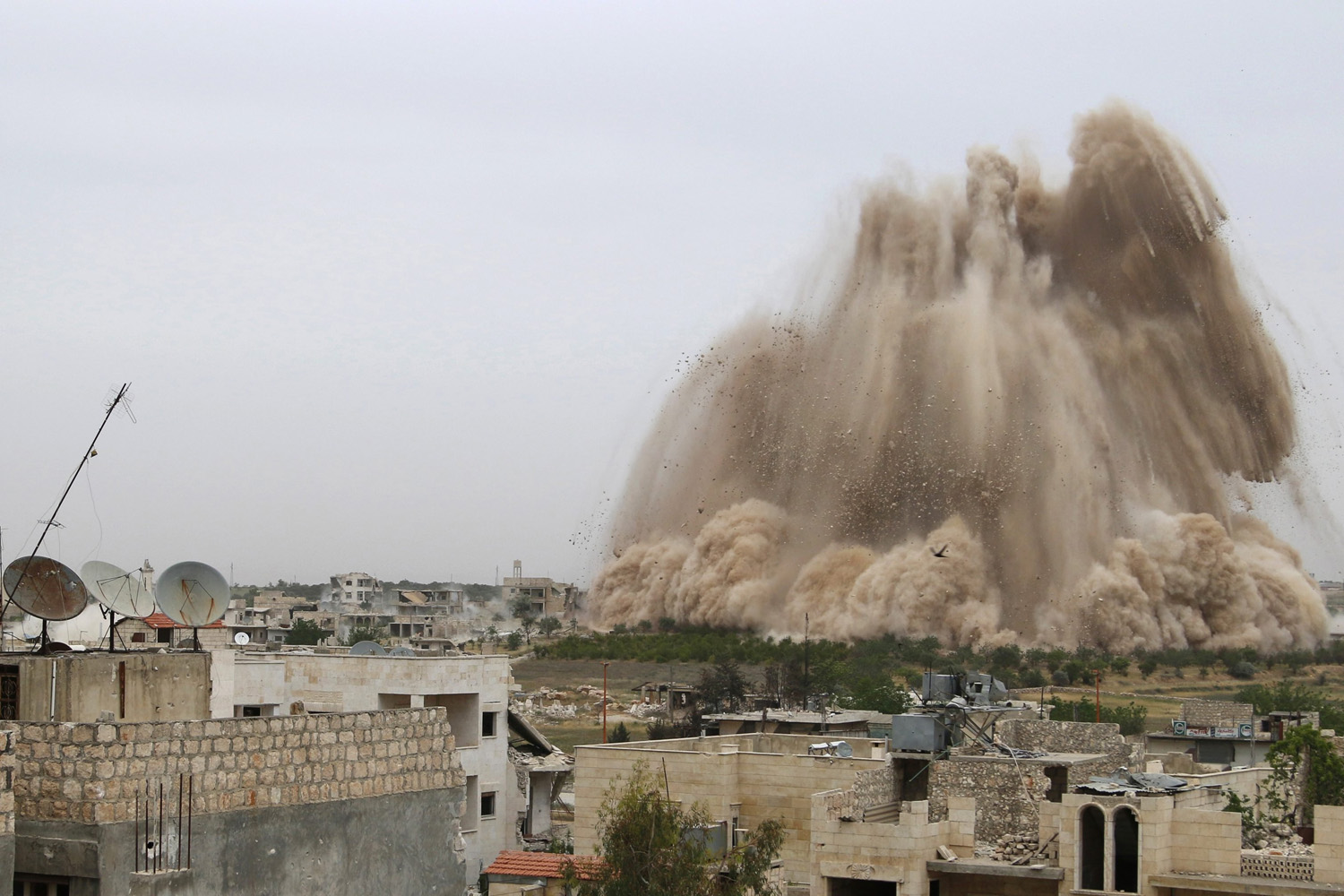 Debris rises in an operation to strike Al-Sahaba checkpoint in Idlib