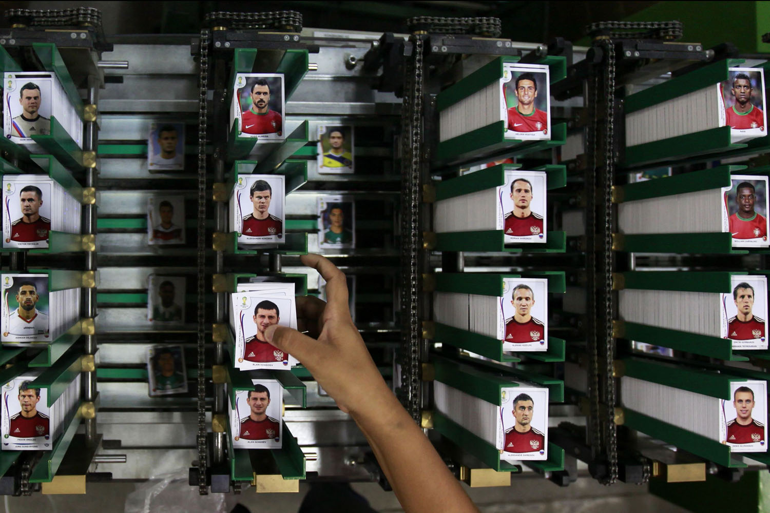 A labourer works at the assembly line of Panini's factory, where the FIFA's Brazil World Cup stickers and albums are been produced, in Tambore, an industrial suburb north of Sao Paulo