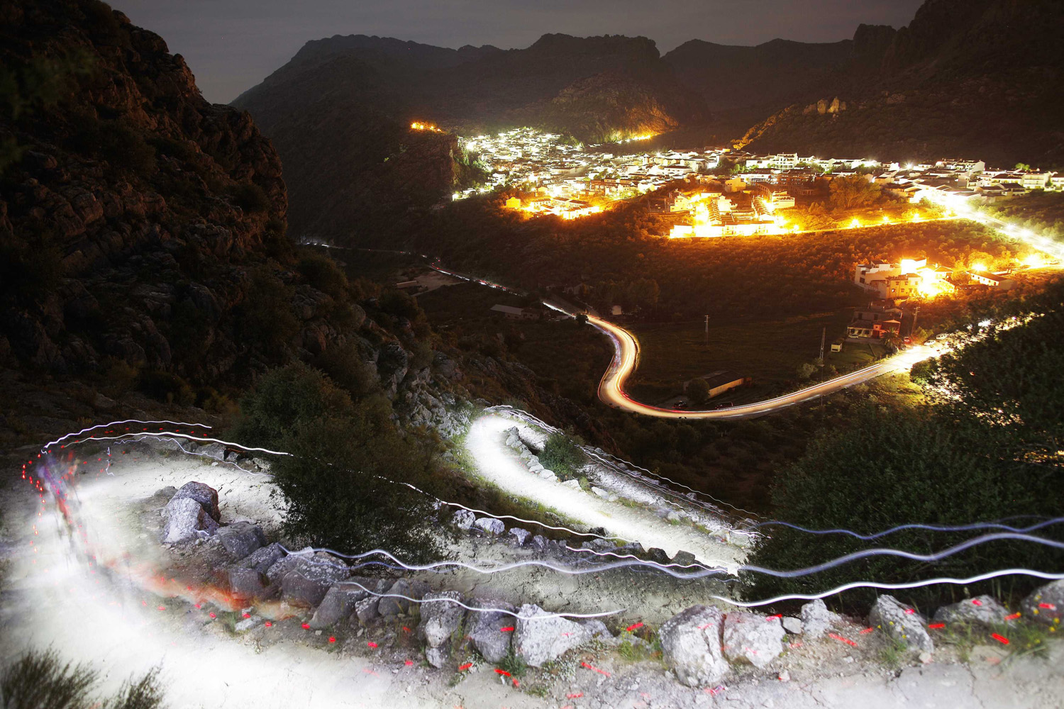 Trails of headlamps are seen as runners make their way to the finish line during the XVII 101km competition on the outskirts of Montejaque