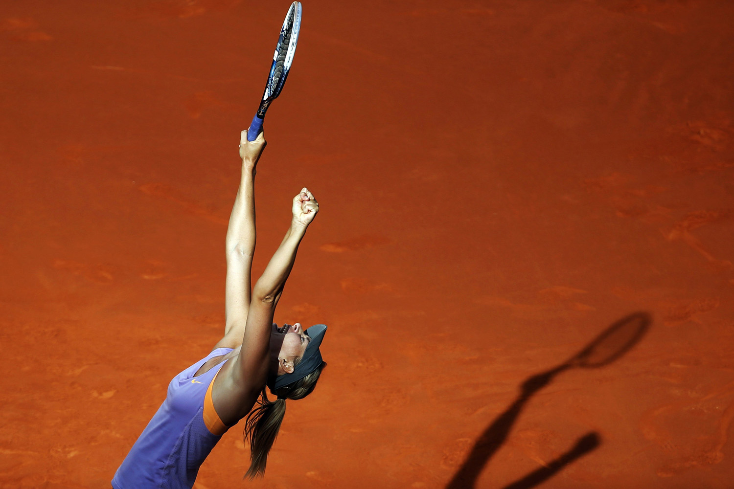 Maria Sharapova of Russia celebrates her victory over Simona Halep of Romania at the end of their women's singles final match at the Madrid Open tennis tournament on May 11, 2014.