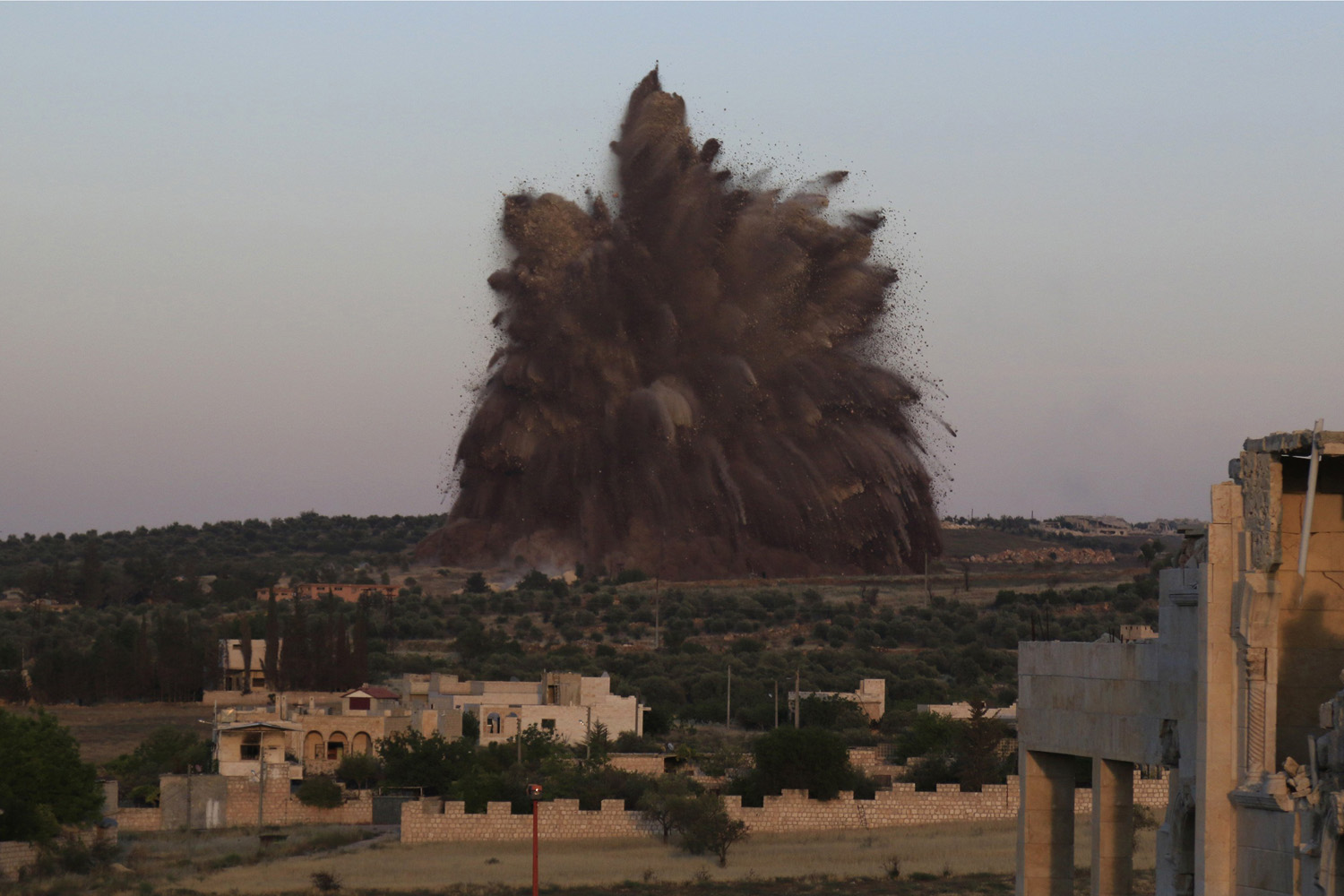 Debris rises during what rebel fighters said was an operation in which they blew up a tunnel targeting the regime's al-Sawadi checkpoint, in Idlib province