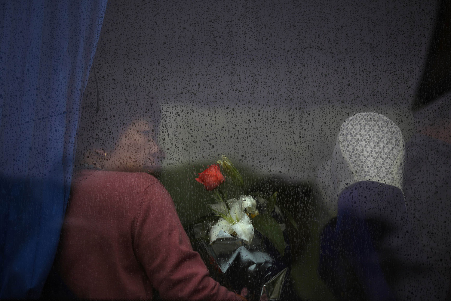 A mourner waits for the bus to depart for a sea burial ceremony in Shanghai