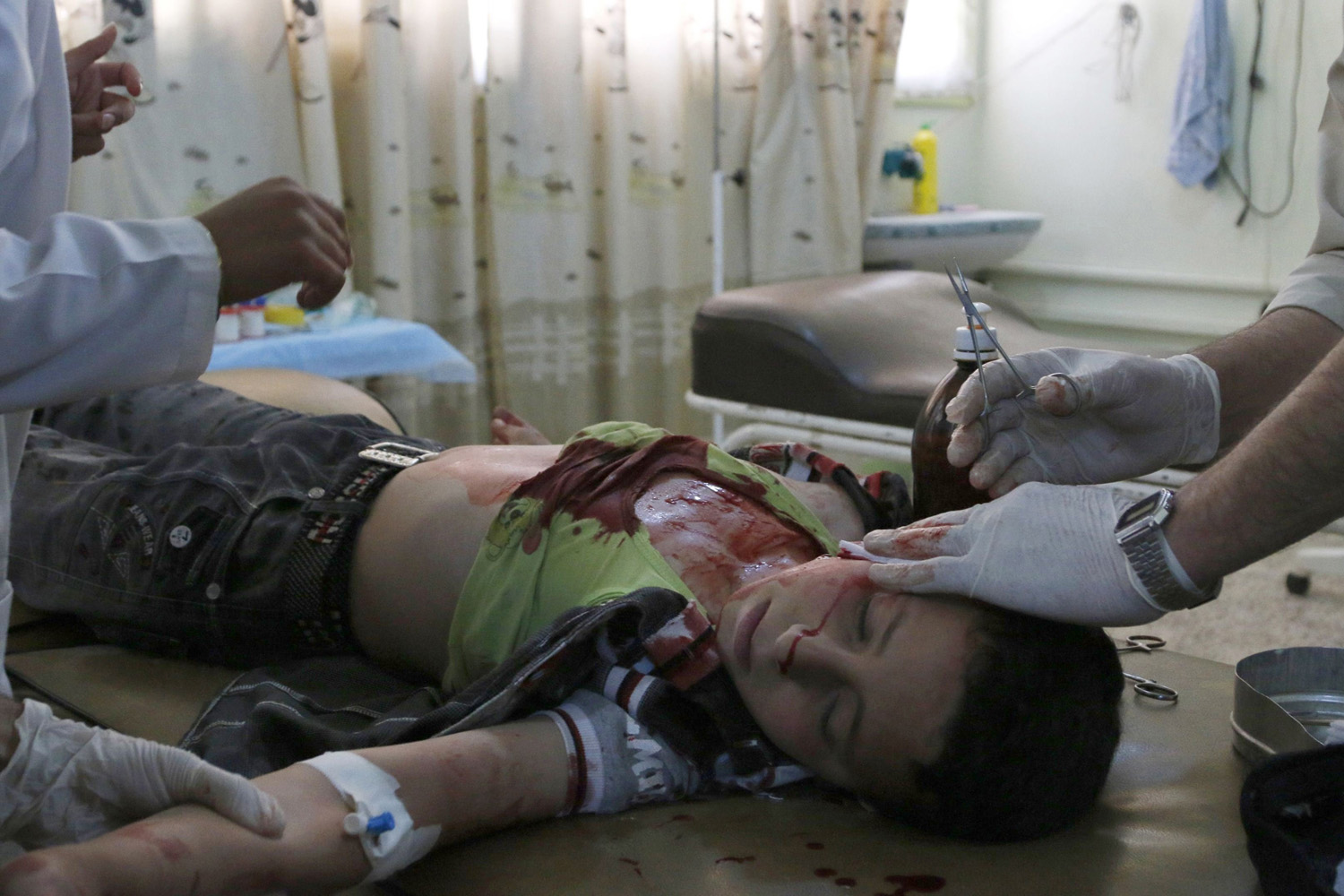 A medic helps a boy, who was injured after what activists say was an air strike by forces loyal to Syrian President Bashar al-Assad, at a hospital in Maarat Al-Nouman, Idlib province