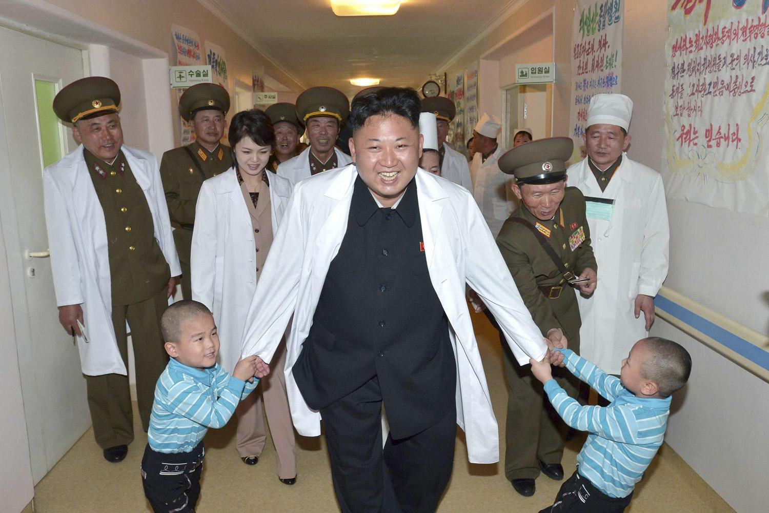 North Korean leader Kim Jong Un plays with children during a visit to the Taesongsan General Hospital in this undated photo released on May 19, 2014.