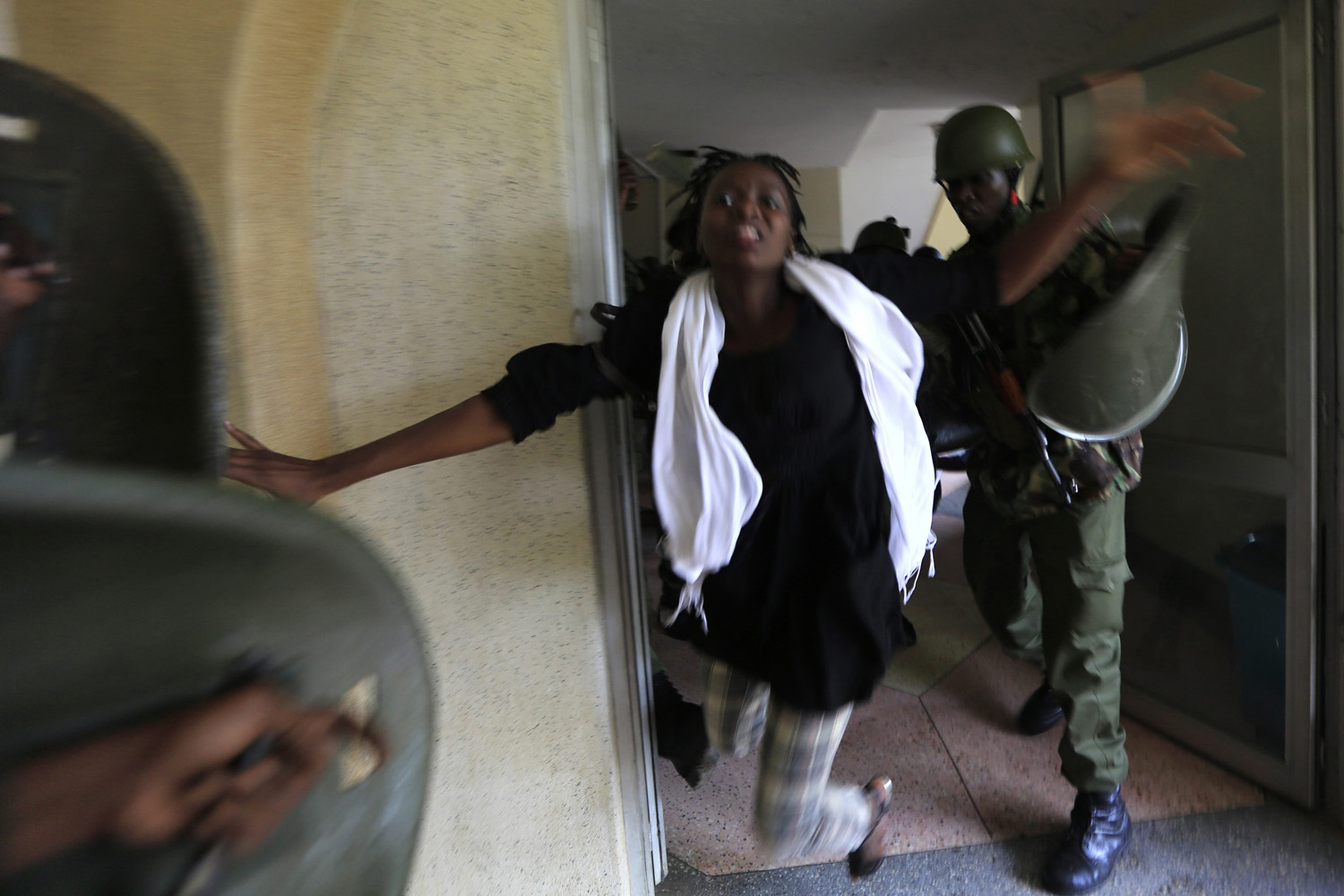 A riot policeman uses a baton to hit a rioting University of Nairobi student in Kenya's capital Nairobi