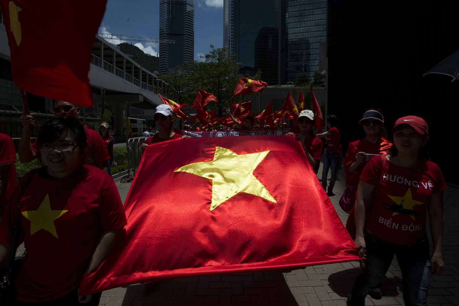 Hong Kong based Vietnamese demonstrators carry Vietnam's flag during a protest against China's territory claim in Hong Kong