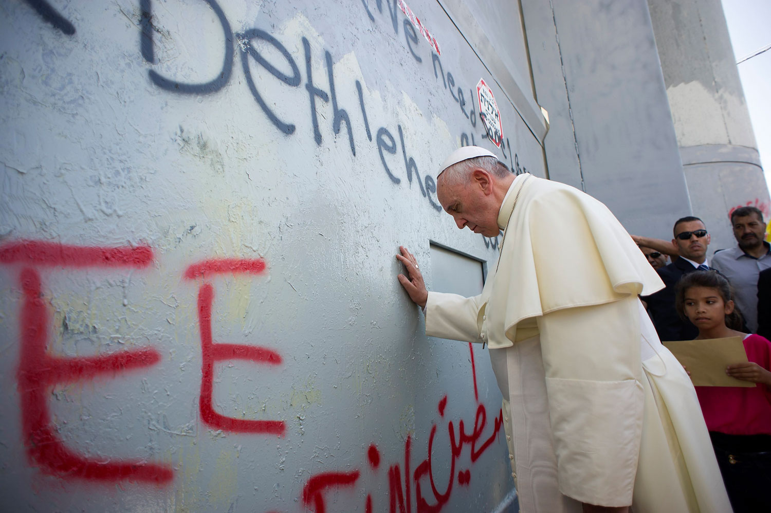 Pope Francis touches the wall that divides Israel from the West Bank, on his way to celebrate a mass in Manger Square, in the West Bank city of Bethlehem on May 25, 2014 (Osservatore Romano—Reuters)