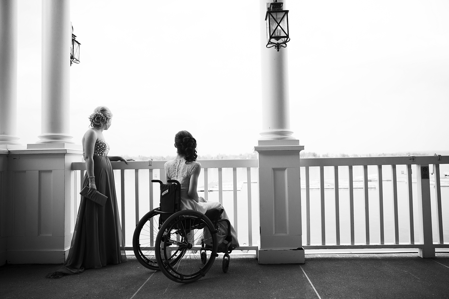 Gena and her friend, Mary, 16, look over the balcony after dinner at the Skaneateles Country Club in Skaneateles, NY.
