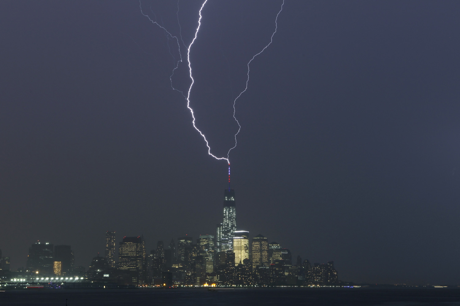 Two bolts of lightning hit the antenna on top of One World Trade Center in Lower Manhattan as an electrical storm moves over New York City on May 23, 2014.