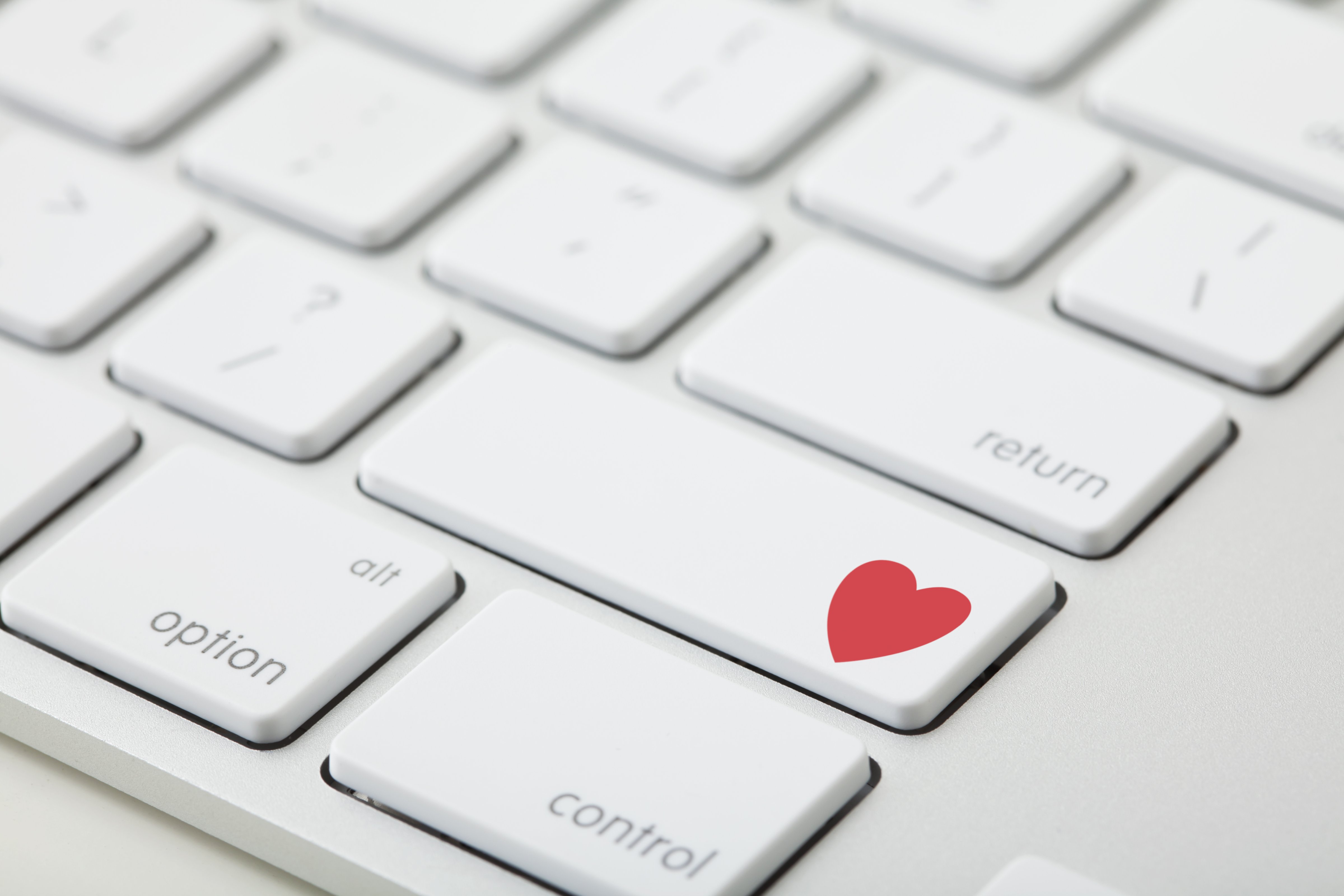 Keyboard with red heart on button, close-up (Vstock&mdash;Getty Images/Tetra images RF)