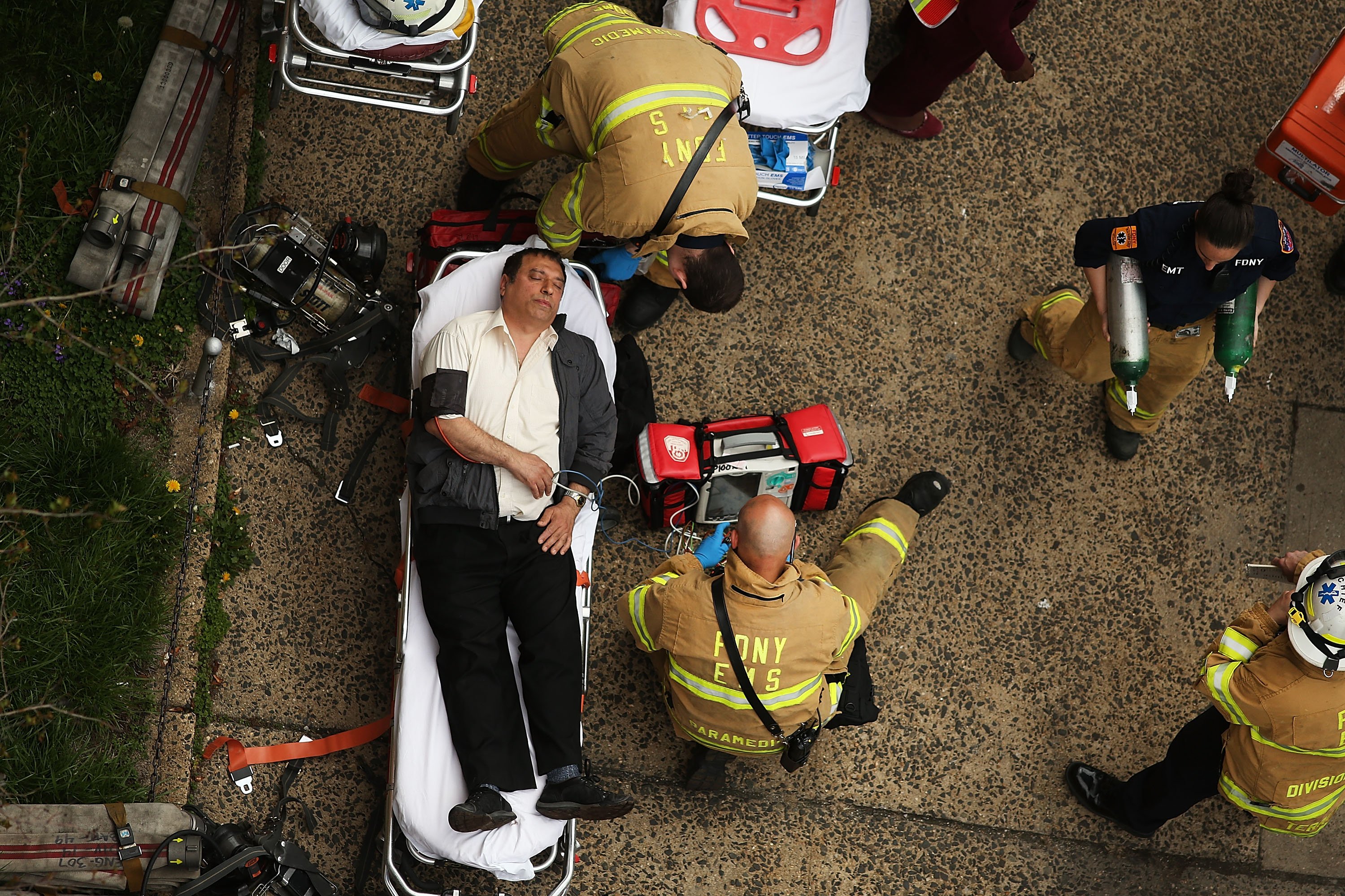An injured man is aided by New York City firefighters after being evacuated from an emergency staircase following an F train derailment in the Woodside neighborhood of the Queens, N.Y., May 2, 2014. (Robin Schwartz for TIME)