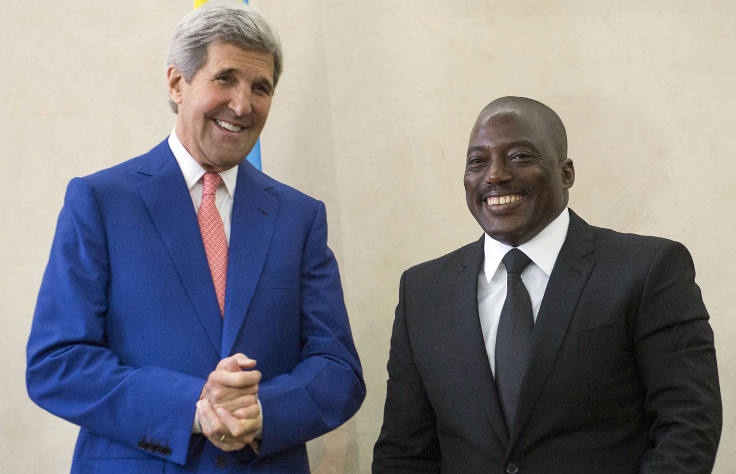 The President of the Democratic Republic of Congo Joseph Kabila, right, welcomes US Secretary of State John Kerry at the Palais de la Nation in Kinshasa on May 4, 2014. (Saul Loeb—AFP/Getty Images)