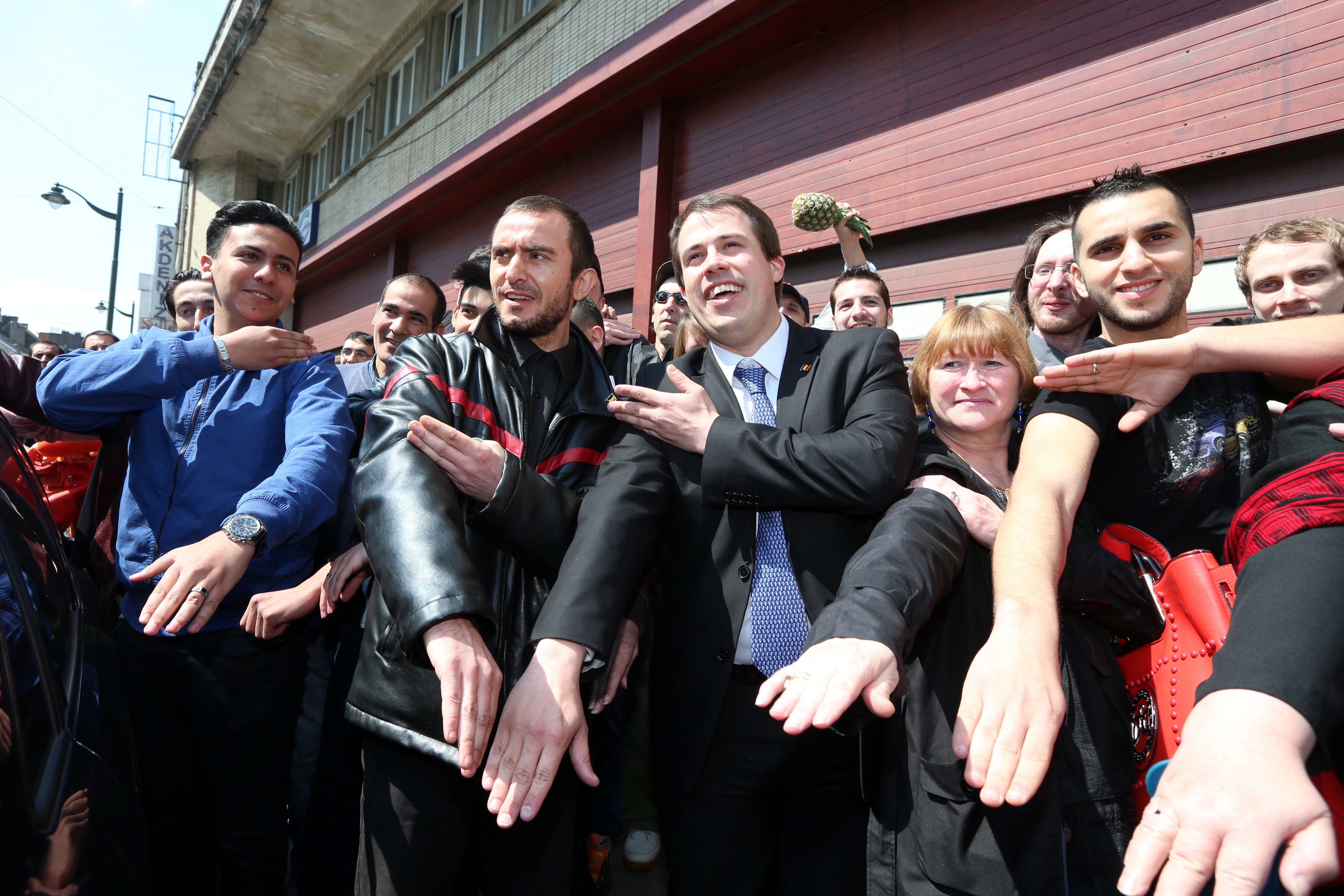 The leader of "Debout Les Belges!," far-right lawmaker Laurent Louis (C) perform the 'quenelle' gesture ahead of the anti-Semitic congress, "First European Conference of Dissidence", organised by Chamber member Laurent Louis in Anderlecht, outside Brussels, on May 4, 2014. (NICOLAS MAETERLINCK—AFP/Getty Images)