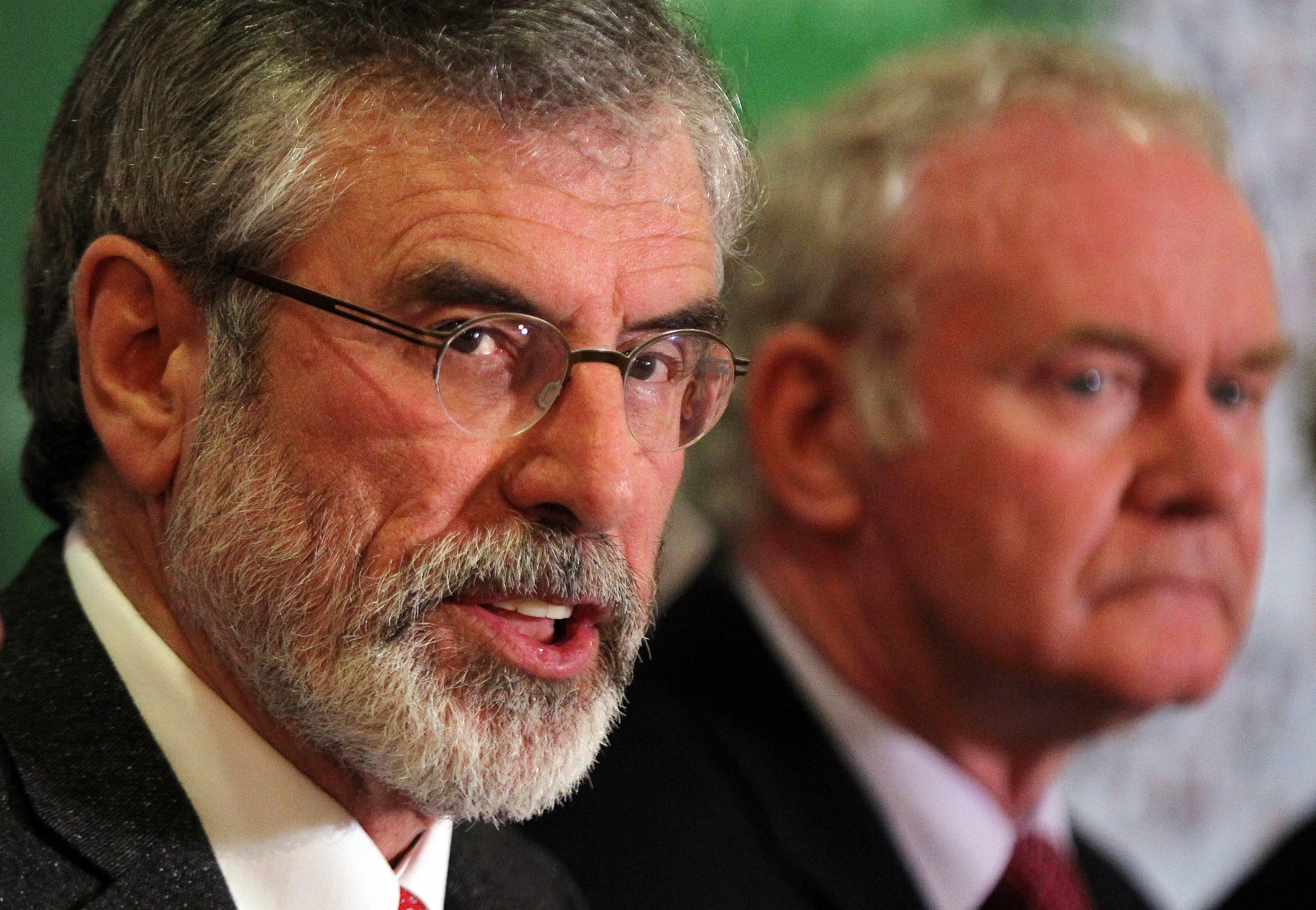 Republican party Sinn Fein leader Gerry Adams, left, next to Sinn Fein politician and Deputy First Minister of Northern Ireland Martin McGuinness,  talks to the media during a press conference at a hotel in Belfast, Northern Ireland, on May 4, 2014 following his release from Antrim police station where he was detained for questioning over a 1972 murder. (Peter Muhly—AFP/Getty Images)
