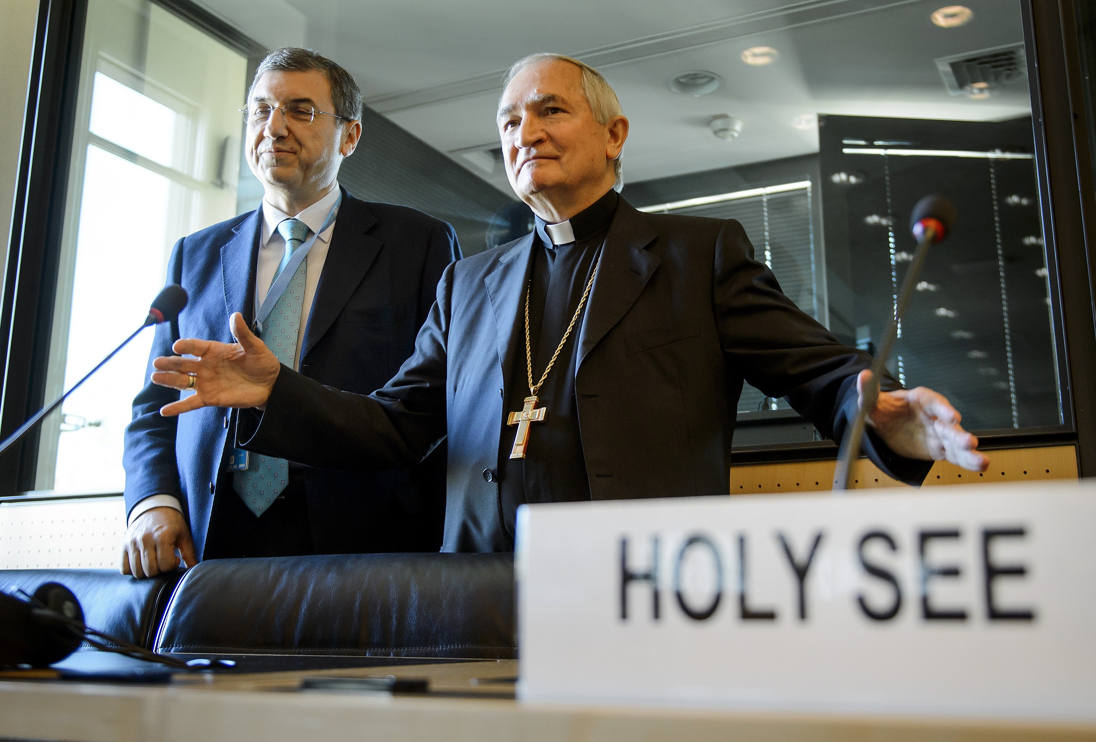 The Vatican's Ambassador to the United Nations Monsignor Silvano Tomasi (R) gestures next to Vatican Secretary of State Professor Vincenzo Buonomo (L) during a hearing before the United Nations (UN) Committee Against Torture on May 5, 2014, in Geneva. (FABRICE COFFRINI—AFP/Getty Images)