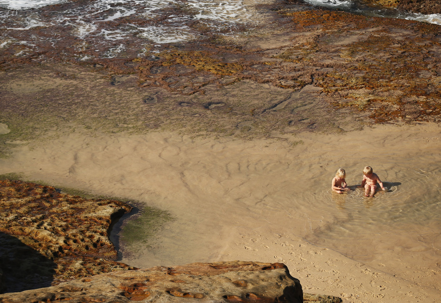 Children play in a pond in Sydney which is experiencing it's hottest May on record, on May 23, 2014.