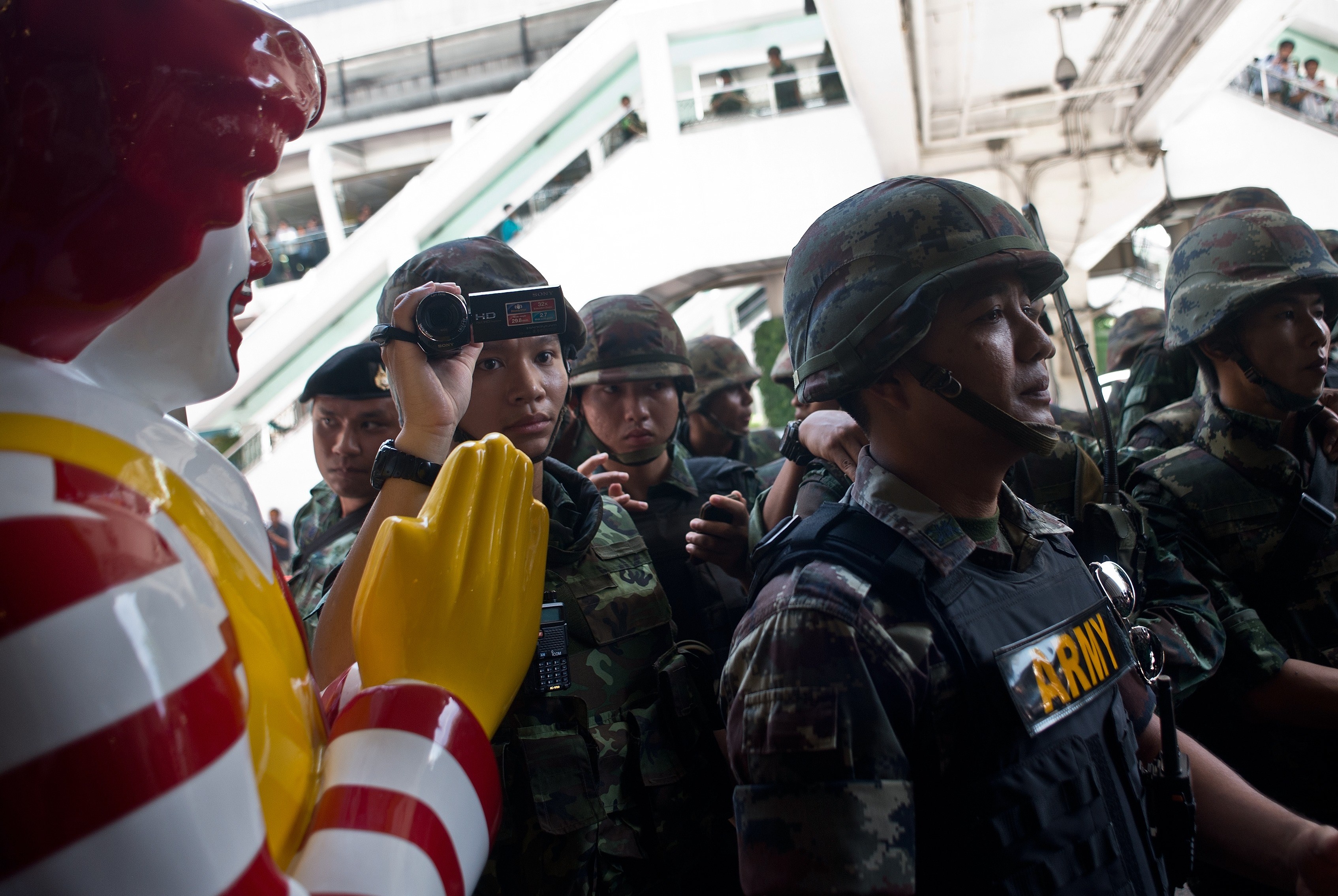 Thai-army soldiers stand guard outside a McDonalds outlet ahead of a planned gathering in Bangkok on May 25, 2014. (MANAN VATSYAYANA—AFP/Getty Images)