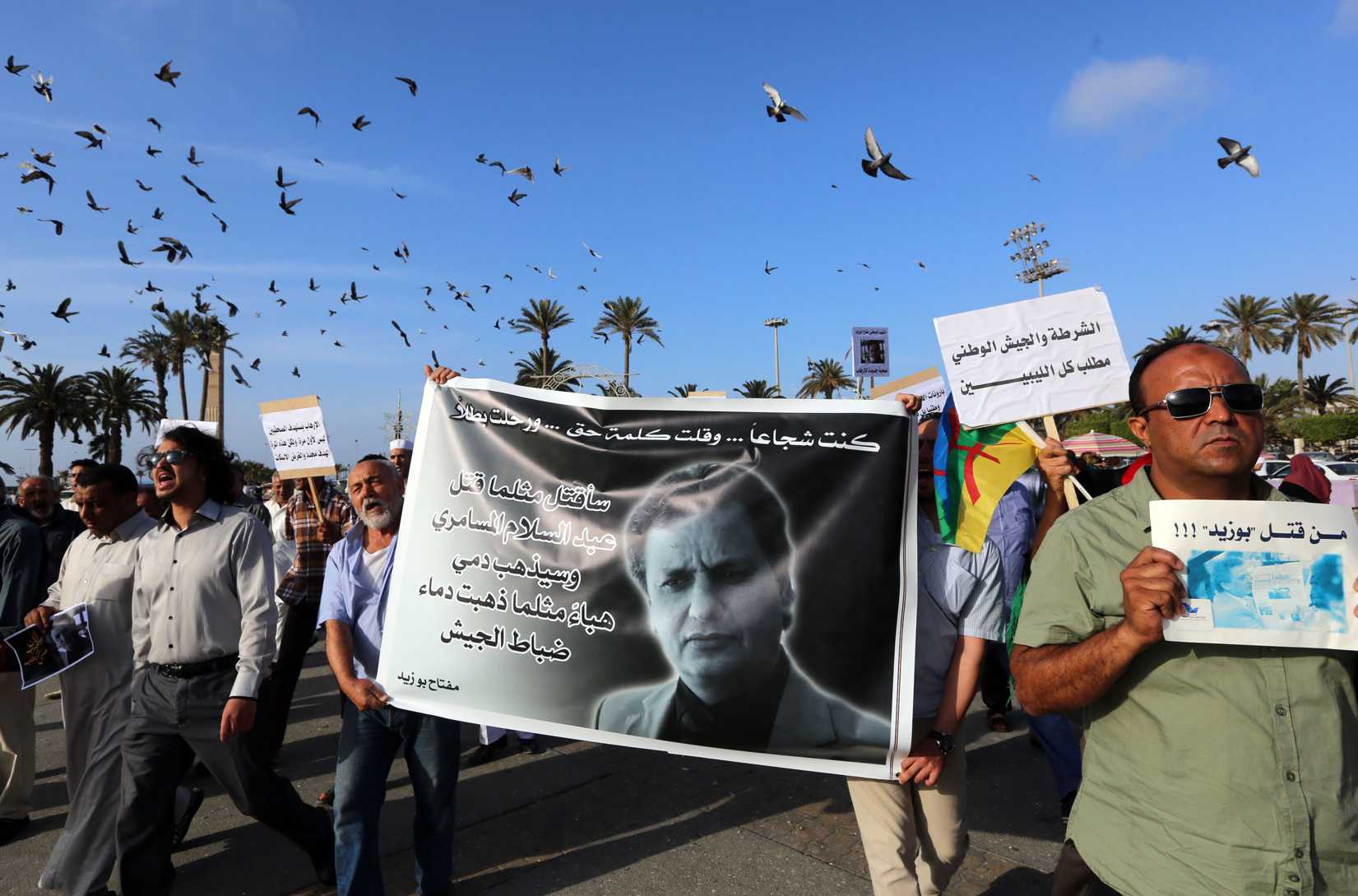 Journalists and others take part in a rally at Tripoli's Martyrs' Square on May 26, 2014 (Mahmud Turkia—AFP / Getty)
