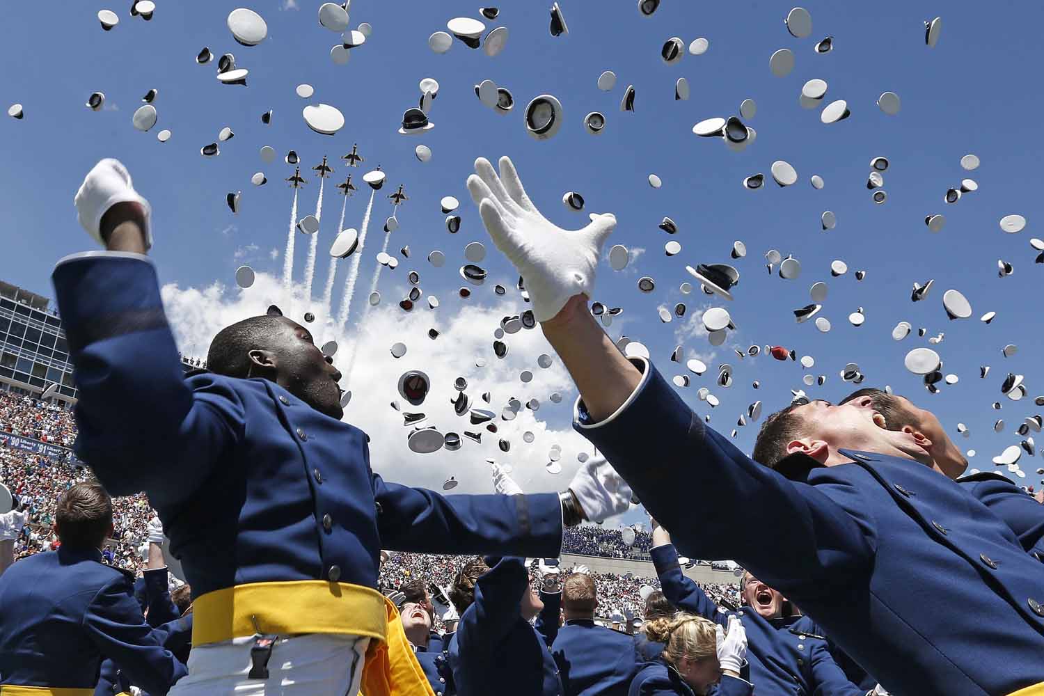May 28, 2014. Air Force Academy graduates throw their caps into the air as F-16 jets from the Thunderbirds make a flyover, at the completion of the graduation ceremony for the class of 2014, at the U.S. Air Force Academy, in Colorado.