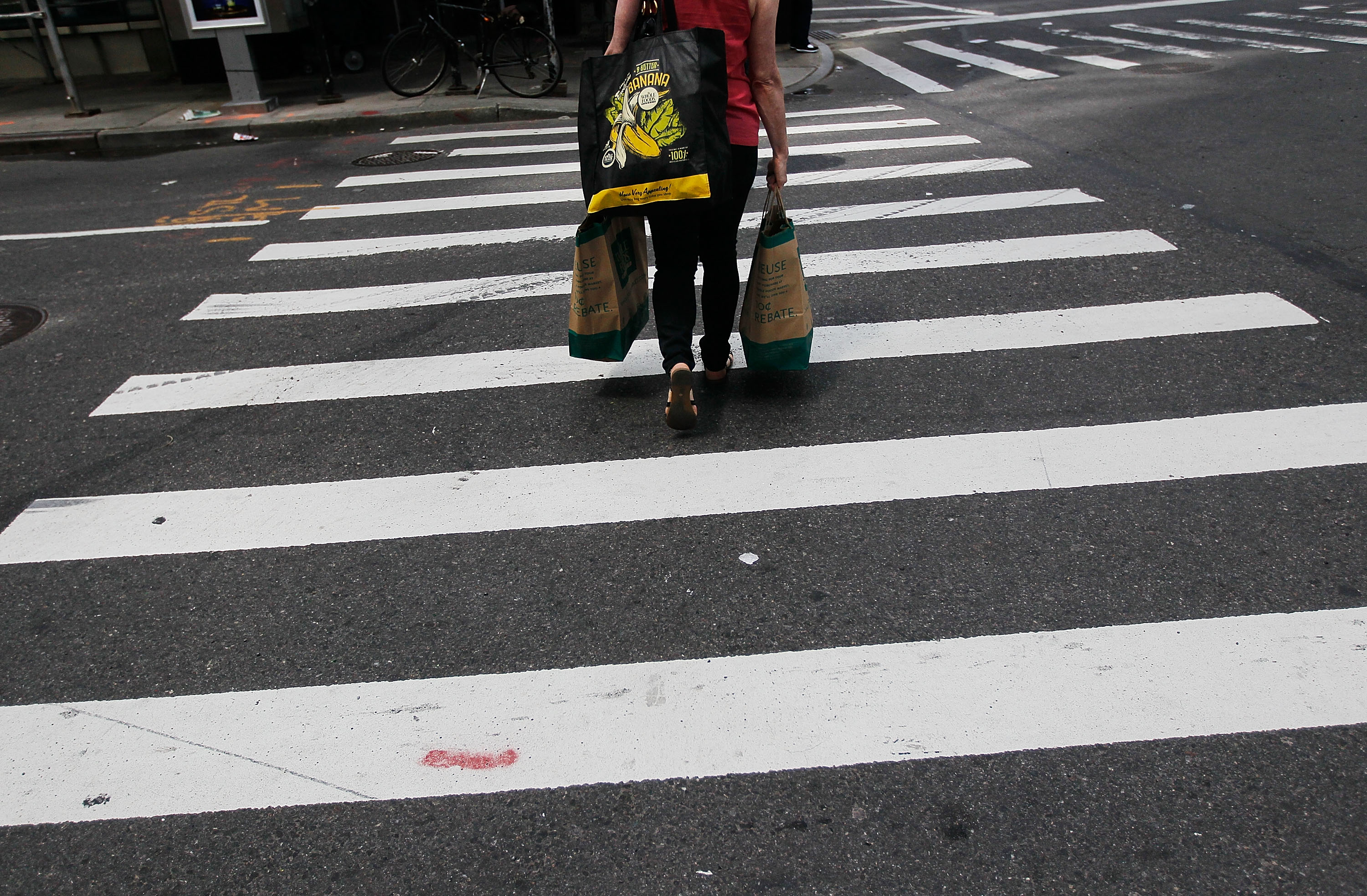 A woman with shopping bags traverses a crosswalk near Columbus Circle April 30, 2010 in New York, New York. (Chris Hondros—Getty Images)