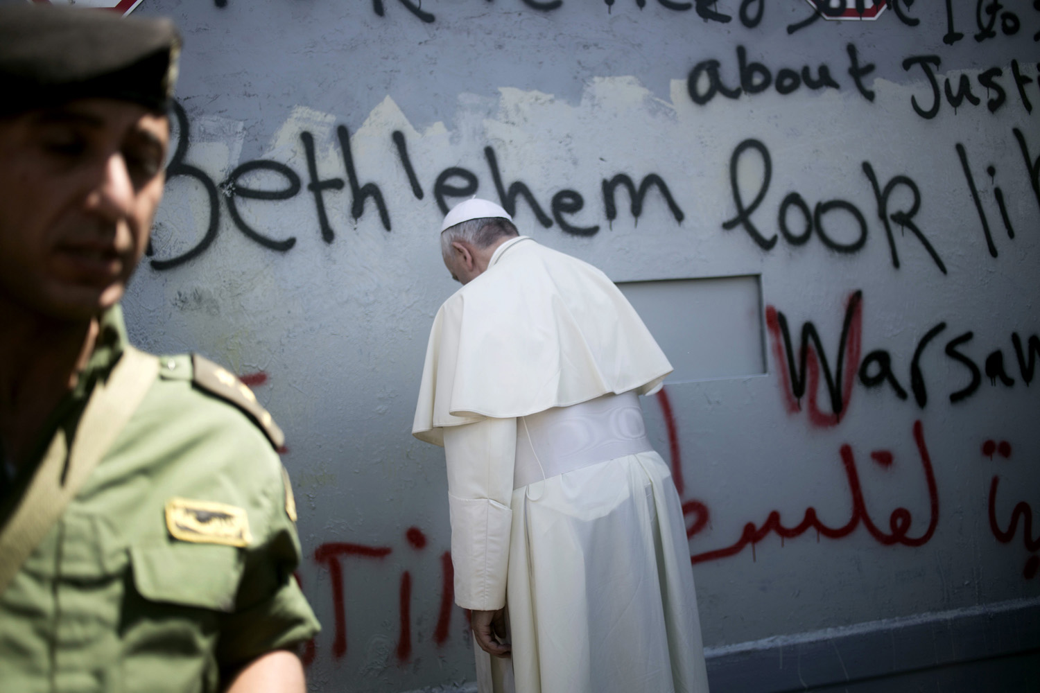 Pope Francis prays at Israel's separation barrier on his way to a mass in Manger Square next to the Church of the Nativity, traditionally believed to be the birthplace of Jesus Christ, in the West Bank town of Bethlehem on May 25, 2014. (Ariel Schalit—AP)