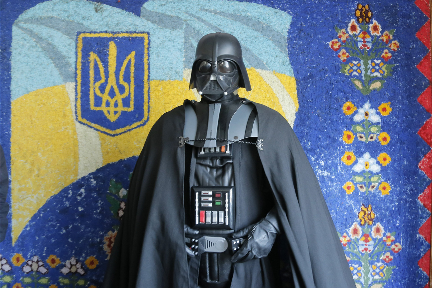 Darth Vader, the Ukrainian Internet Party mayoral candidate for Kiev and Odessa, speaks to the press in front of a painting of the Ukrainian flag at a polling station during the presidential and mayoral elections in Kiev, Ukraine on May, 25, 2014.