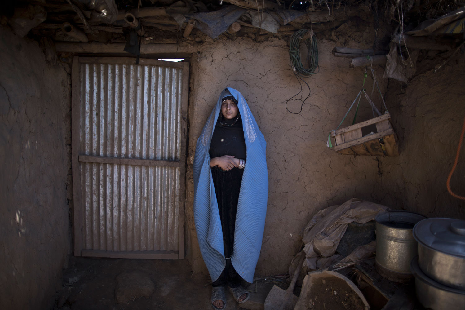 Afghan refugee Fareeda Abdulgafour, 20, a mother of one child, at her mud house in a slum on the outskirts of Islamabad on March 30, 2014. Nine years ago Abdulgafour and her parents fled the violence in Jalalabad.
                              
                               I am a widow. My husband died in a car accident. My boy is my life, and I will live this life taking care of my son.