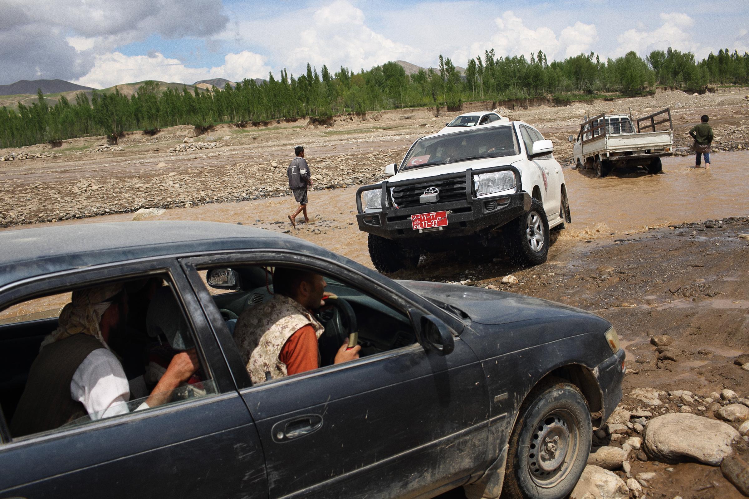 The road from the capital of Badakhshan, Faizabad to Abi Barik, is becoming increasingly hard to pass as trucks filled with aid dig deep ruts in river crossings, further hampering already compromised aid efforts, May 6, 2014.