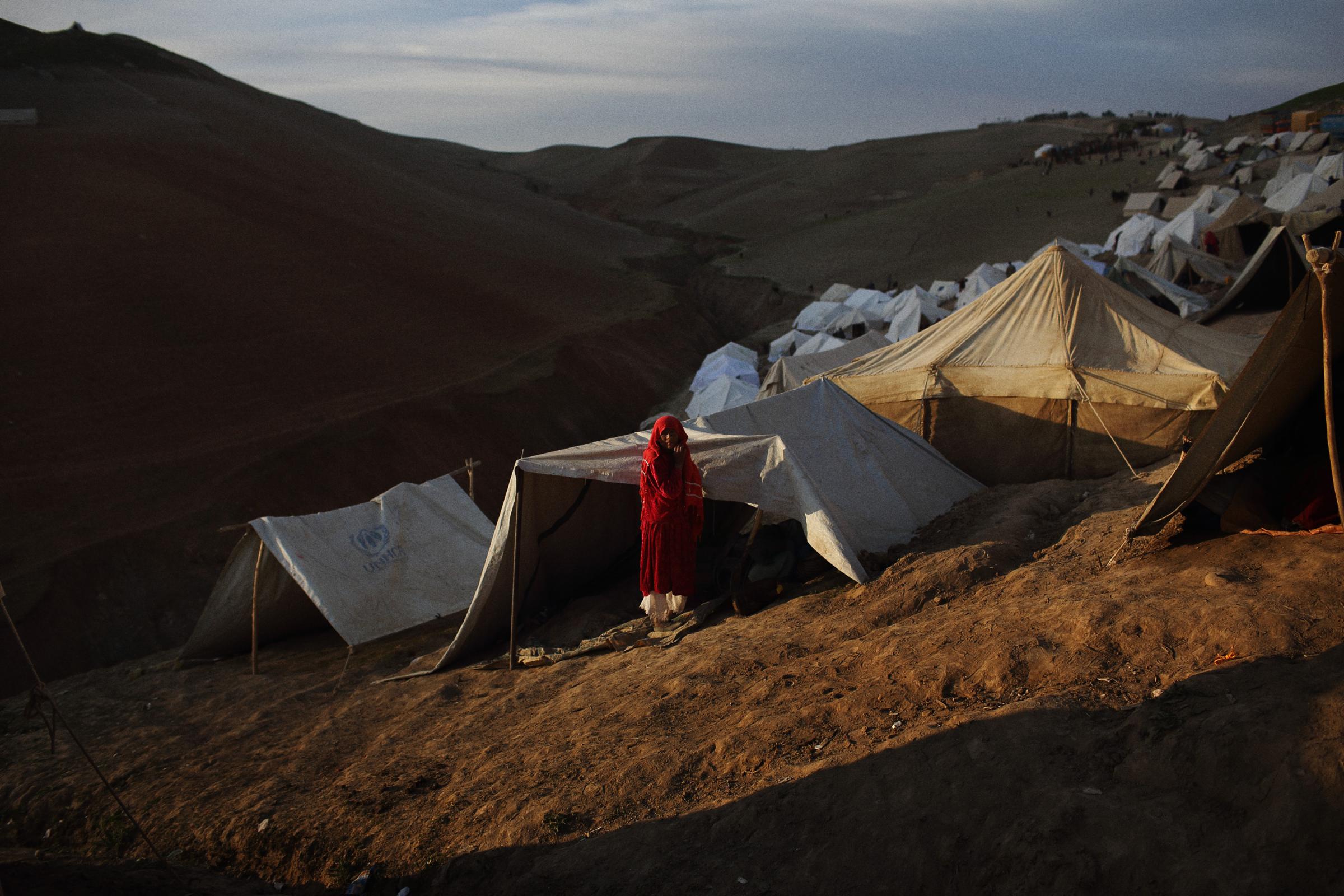A woman by her tent on the side of a steep hill at the top of Abi Barik, May 6, 2014.
