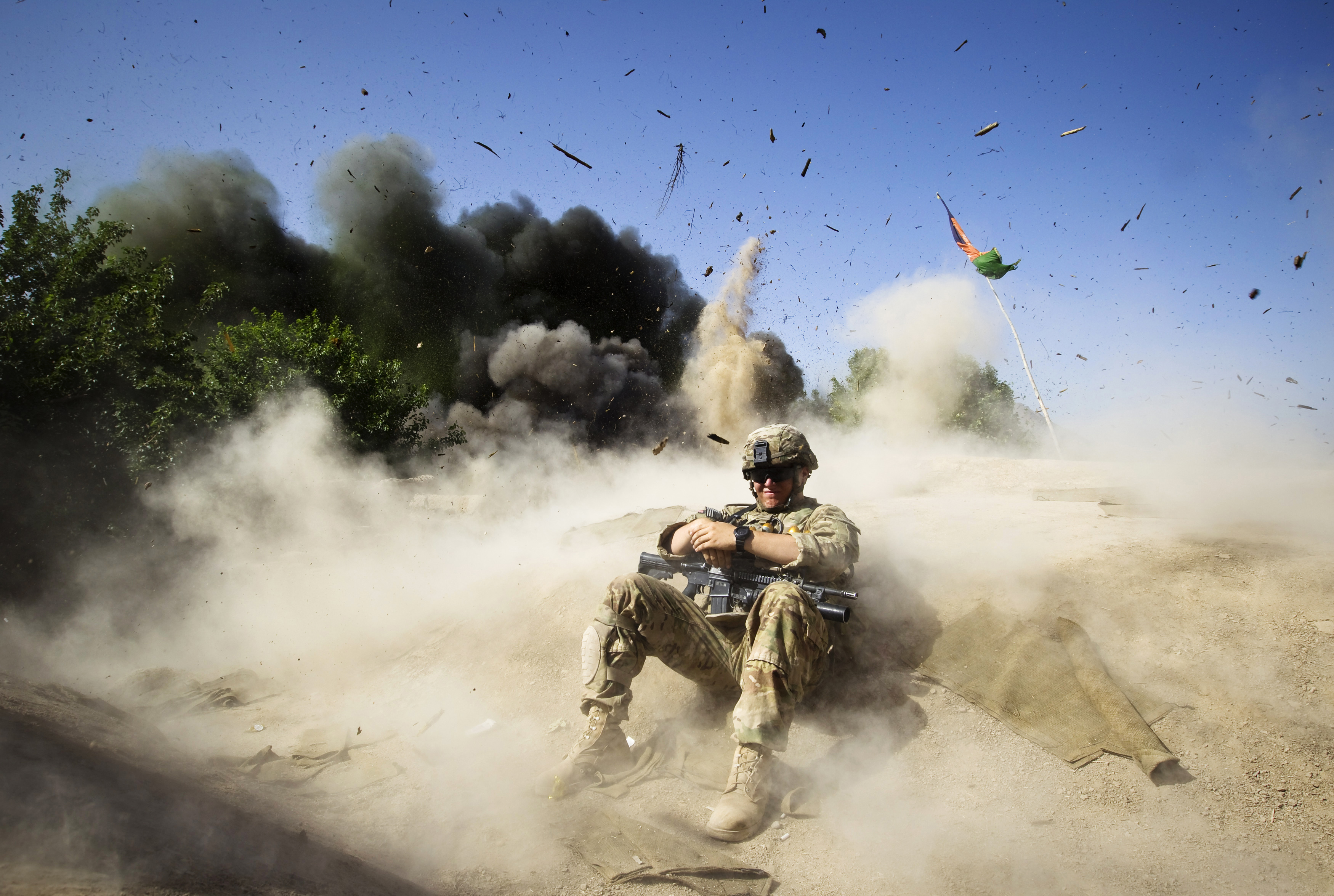 Jake Beaudoin, a U.S. Army Private of 82nd Airborne Division, takes cover during a controlled detonation to clear an area for setting up a check point in Zahri district of Kandahar province