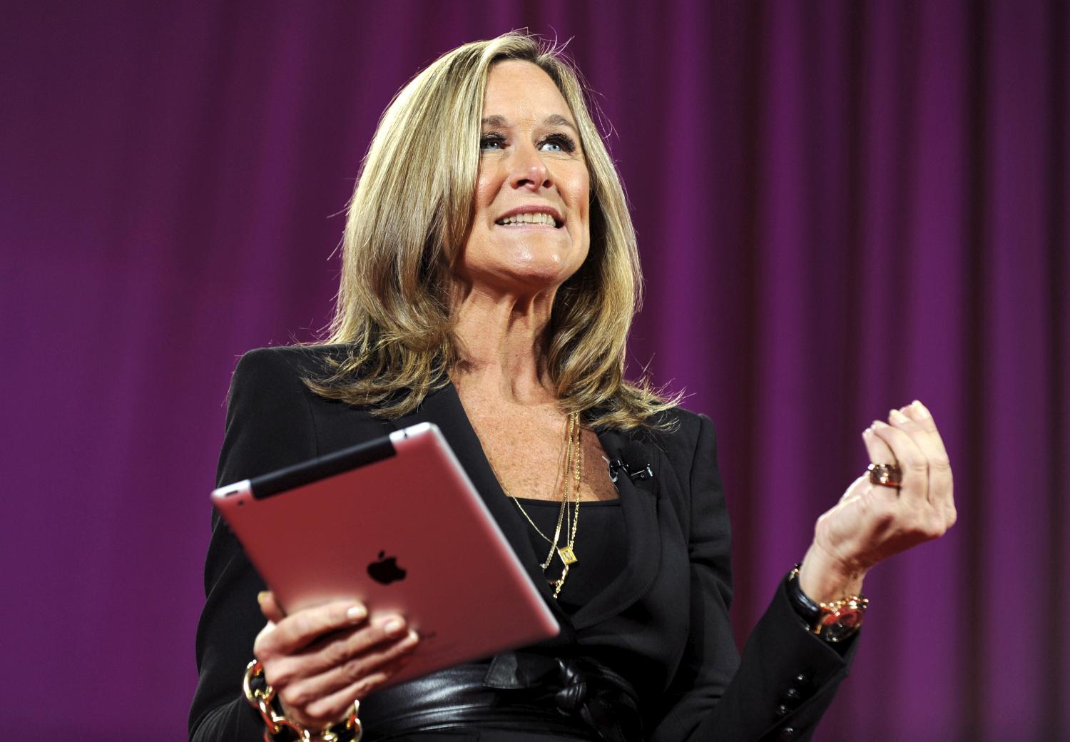 Angela Ahrendts, former Burberry CEO and new Apple retail SVP, seen holding an iPad in 2013 (Peter Foley -- Bloomberg / Getty Images)
