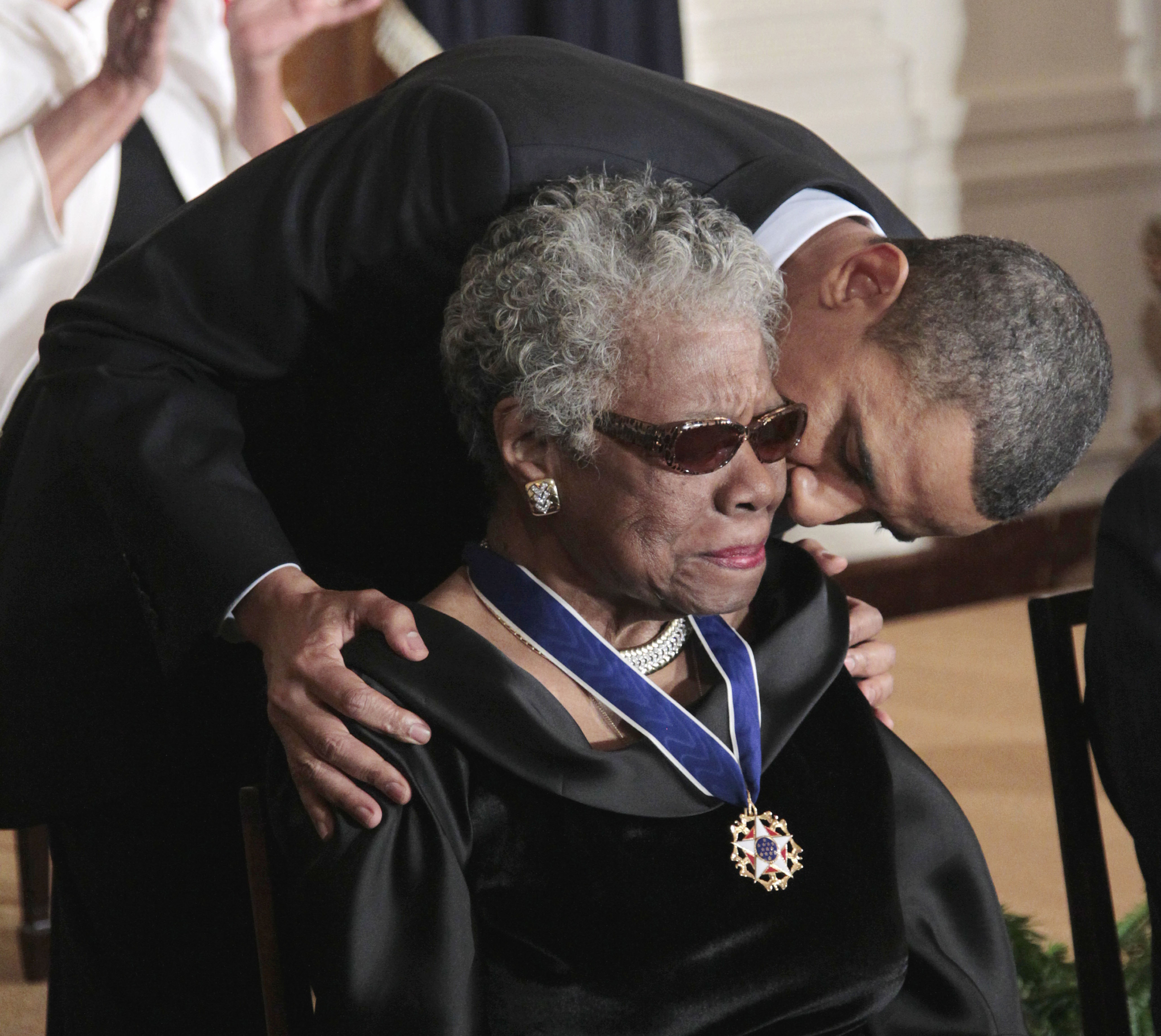President Barack Obama kisses Angelou after awarding her the 2010 Medal of Freedom, America's highest civilian honor, during a ceremony in the East Room of the White House in Washington, Tuesday, Feb. 15, 2011.