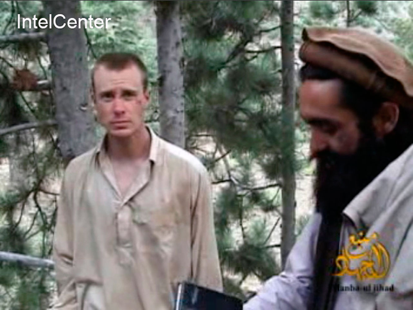 This file image provided by IntelCenter on Dec. 8, 2010, shows a frame grab from a video released by the Taliban containing footage of a man believed to be Bowe Bergdahl, left. (IntelCenter/AP)