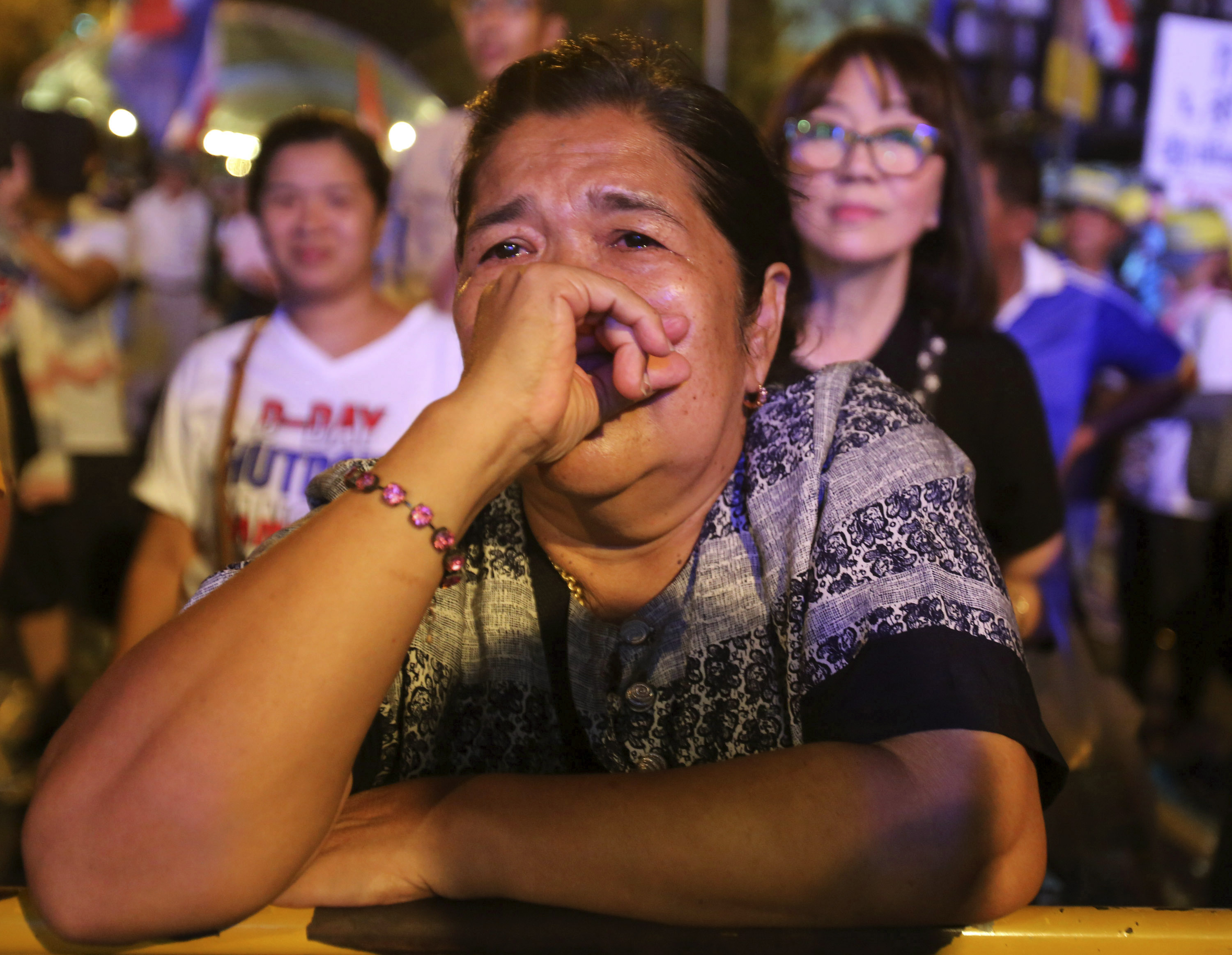 An antigovernment demonstrator cries before she leaves a protest site after soldiers staged a coup in Bangkok on Thursday, May 22, 2014. (Sakchai Lalit—ASSOCIATED PRESS)