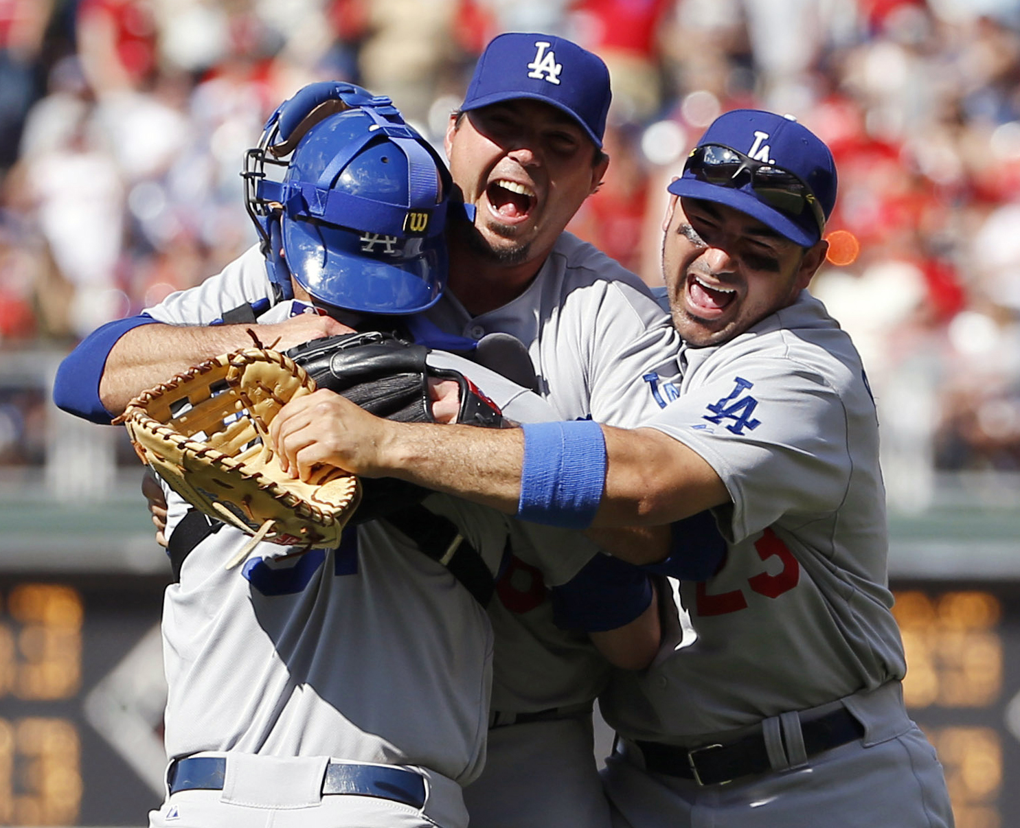 Los Angeles Dodgers starting pitcher Josh Beckett, center, celebrates with catcher Drew Butera, left, and first baseman Adrian Gonzalez after pitching a no-hitter baseball game against the Philadelphia Phillies, Sunday, May 25, 2014, in Philadelphia.