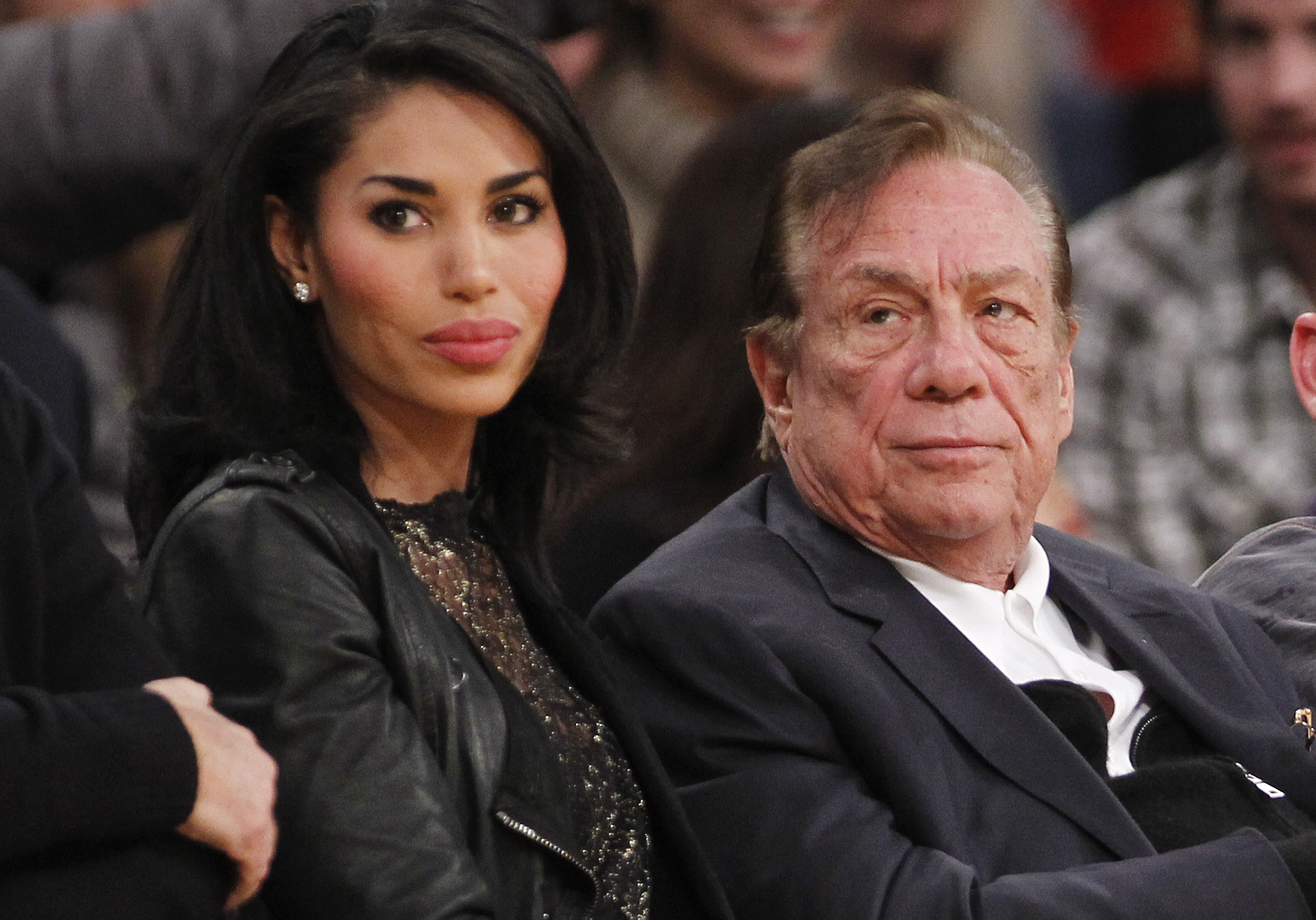 Los Angeles Clippers owner Donald Sterling, right, and V. Stiviano, left, watch the Clippers play the Los Angeles Lakers during an NBA preseason basketball game in Los Angeles on Monday, Dec. 19, 2011. (Danny Moloshok—AP)