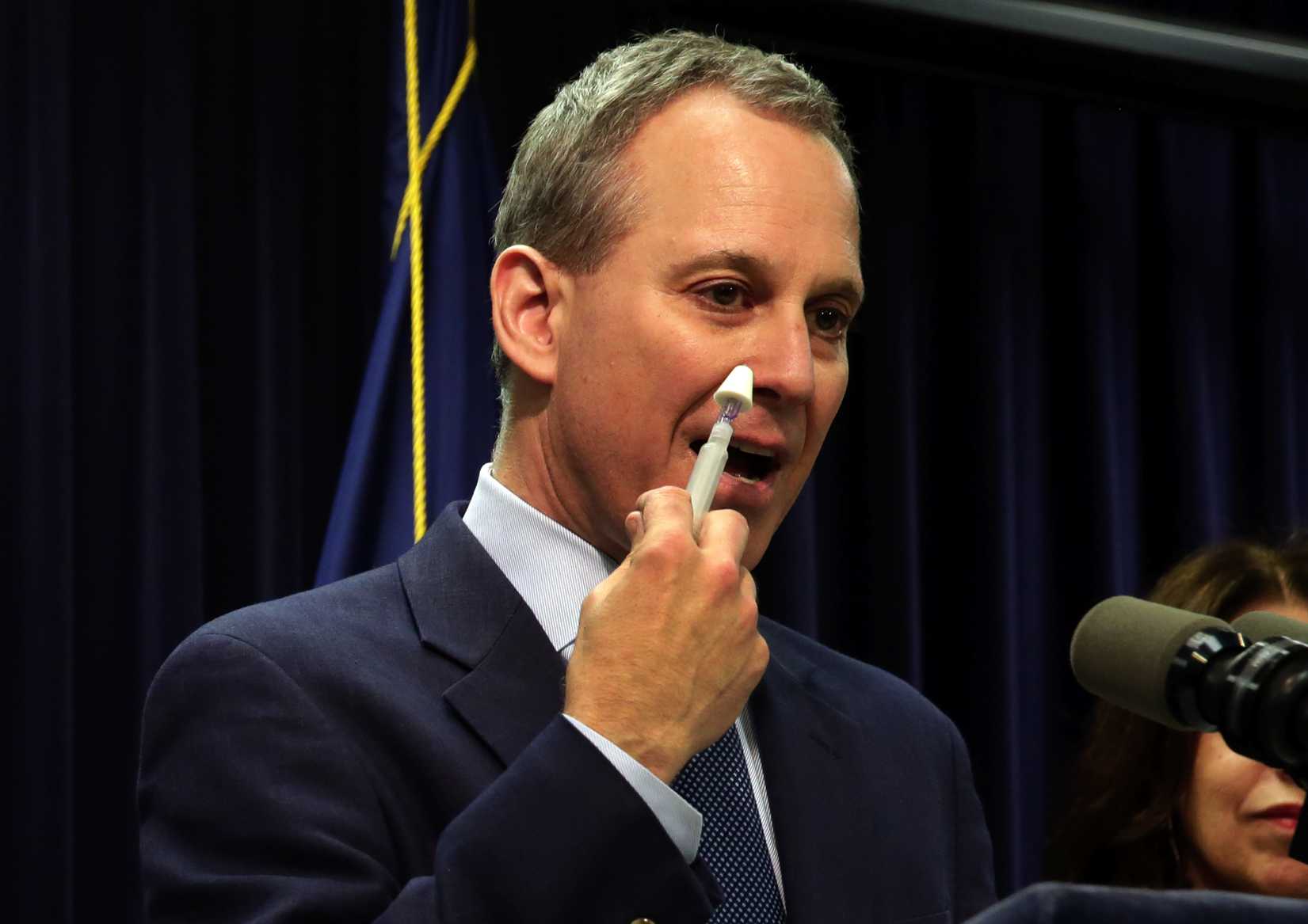 New York State Attorney General Eric Schneiderman demonstrates an inhaler of naloxone, a drug to be included in an overdose-prevention rescue kit, during a news conference in New York City on May 27, 2014 (Richard Drew—AP)