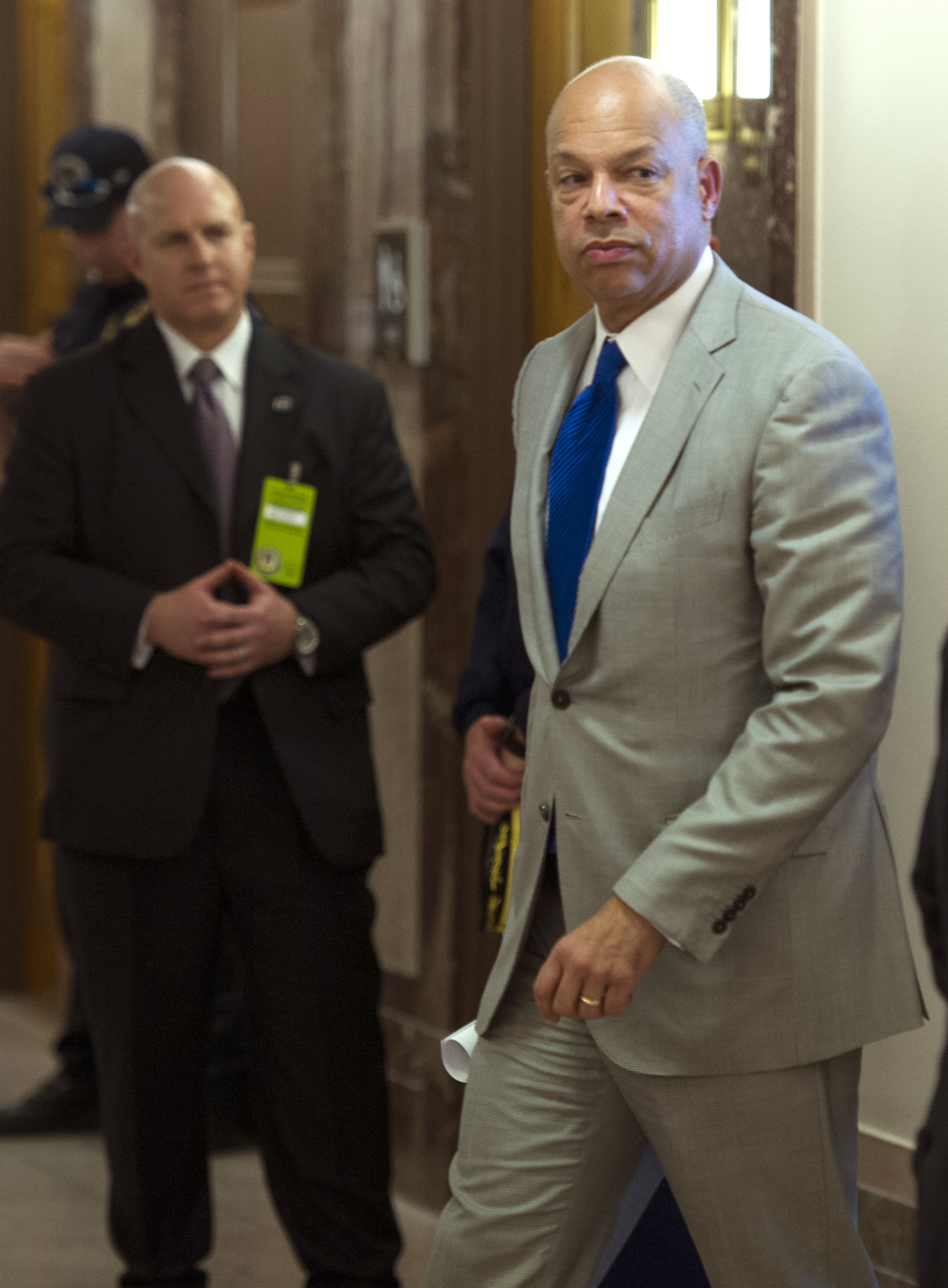 Homeland Security Secretary Jeh Johnson walks to a hearing room to answer questions before a closed meeting of the Senate Homeland Security Committee in Washington, D.C., on April 1, 2014. (Cliff Owen—AP)