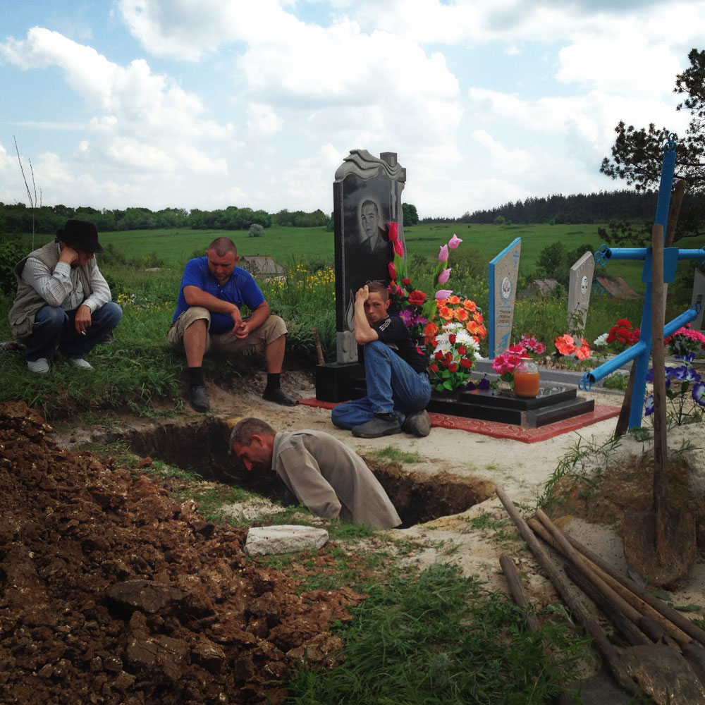 May 15, 2014. Friends and family of Lena Ott, 42, dig her grave in a cemetery in Starovarvarovka, Ukraine.