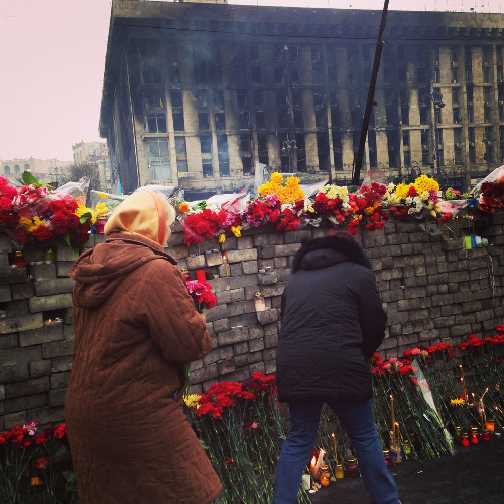 Feb. 23, 2014. Women place flowers at a memorial in Kyiv, Ukraine after the EuroMaidan protests.