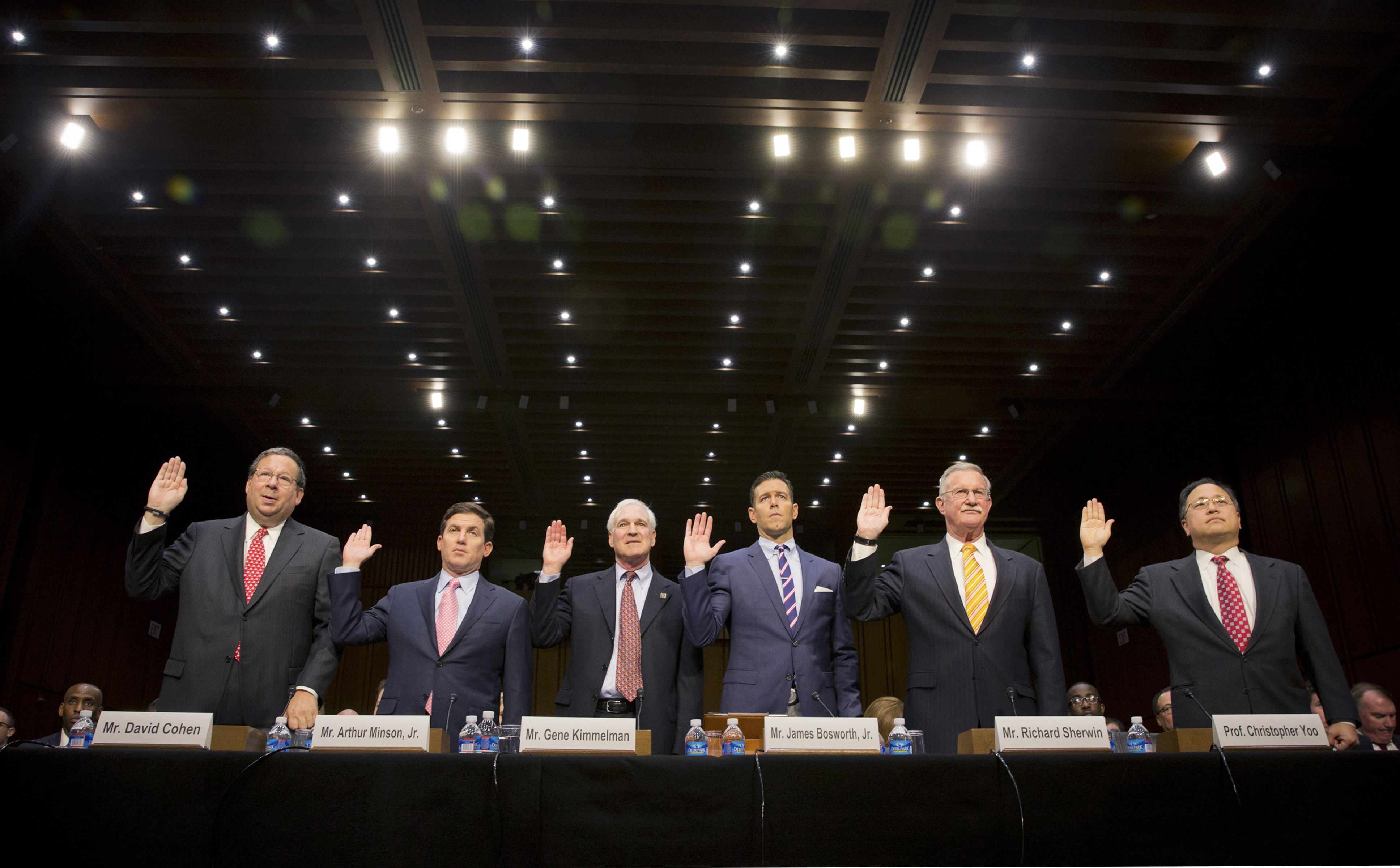 Cable company executives and others who will testify are sworn in at a Senate Judiciary Committee hearing to examine Comcast's proposed takeover of Time Warner Cable in Washington on April 9, 2014. (Stephen Crowley—The New York Times/Redux)