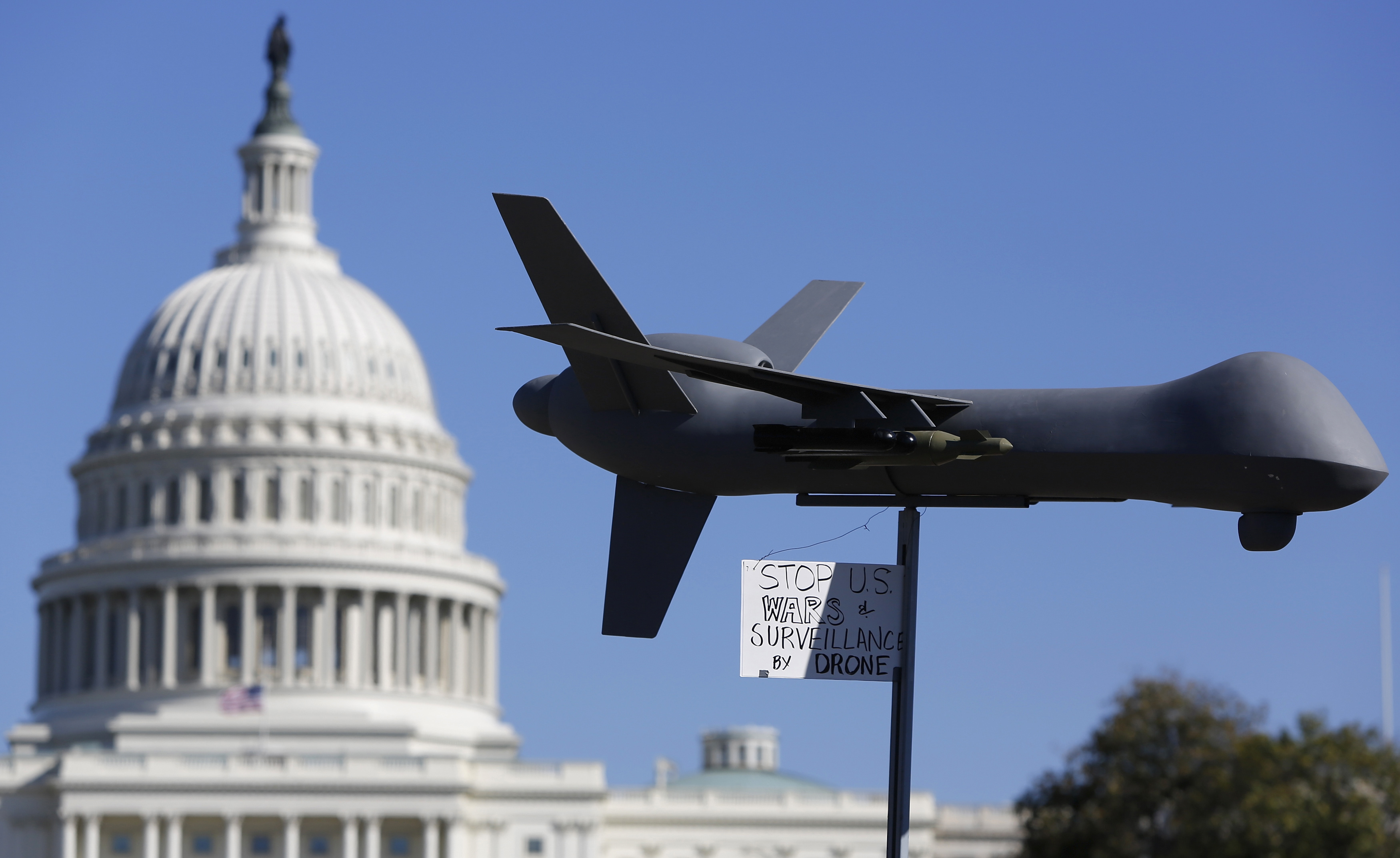 Demonstrators deploy model of U.S. drone aircraft at "Stop Watching Us: A Rally Against Mass Surveillance" near U.S. Capitol in Washington