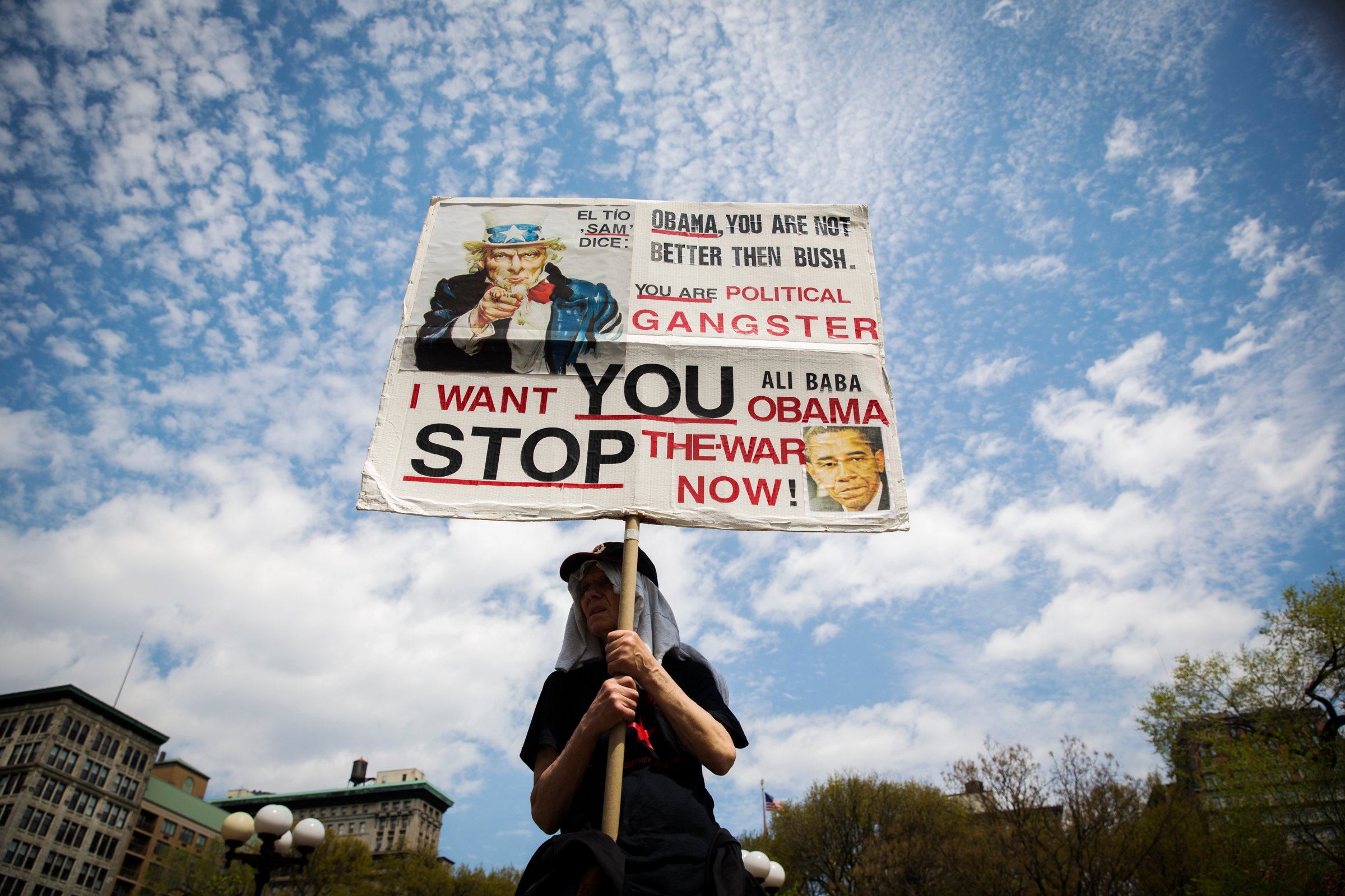 A demonstrator holds up a sign protesting the Obama administration's use of drones during May Day demonstrations in New York