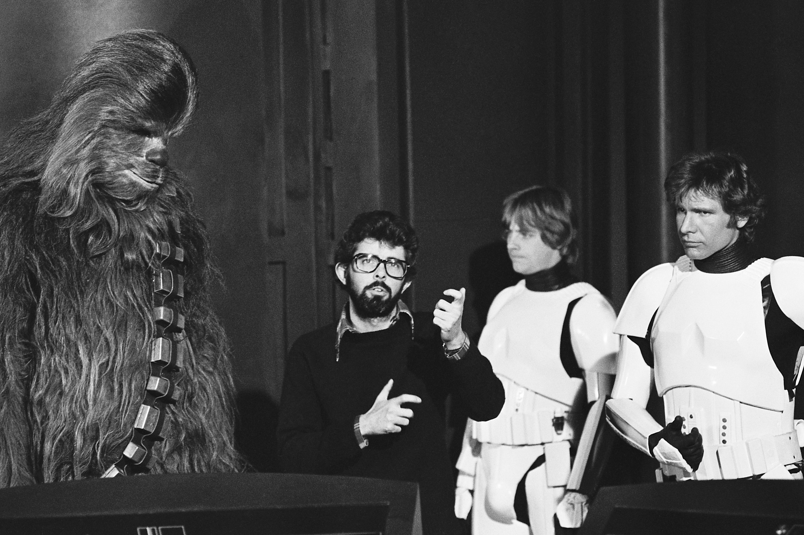 Lucas with Peter Mayhew (Chewbacca), along with Hamill and Ford on the set of Episode IV. (Zalika Azim)