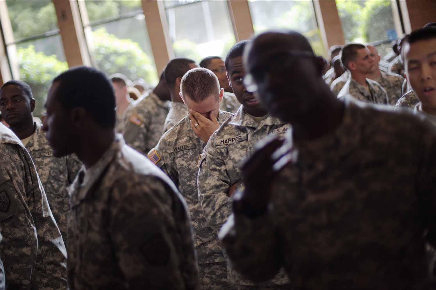May 29, 2014. Sgt. Shaun Waller, of Winder, Ga., center, with the Georgia National Guard 876th Vertical EN Company waits with his fellow soldiers to enter a departure ceremony before the unit deploys to Afghanistan,  in Toccoa, Ga.